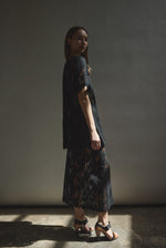 Editorial image of a model in the black French lace Kamperett Jette Tee.