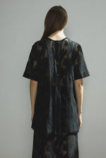 Detail of the wide button placket on the black French lace Kamperett Jette Tee.