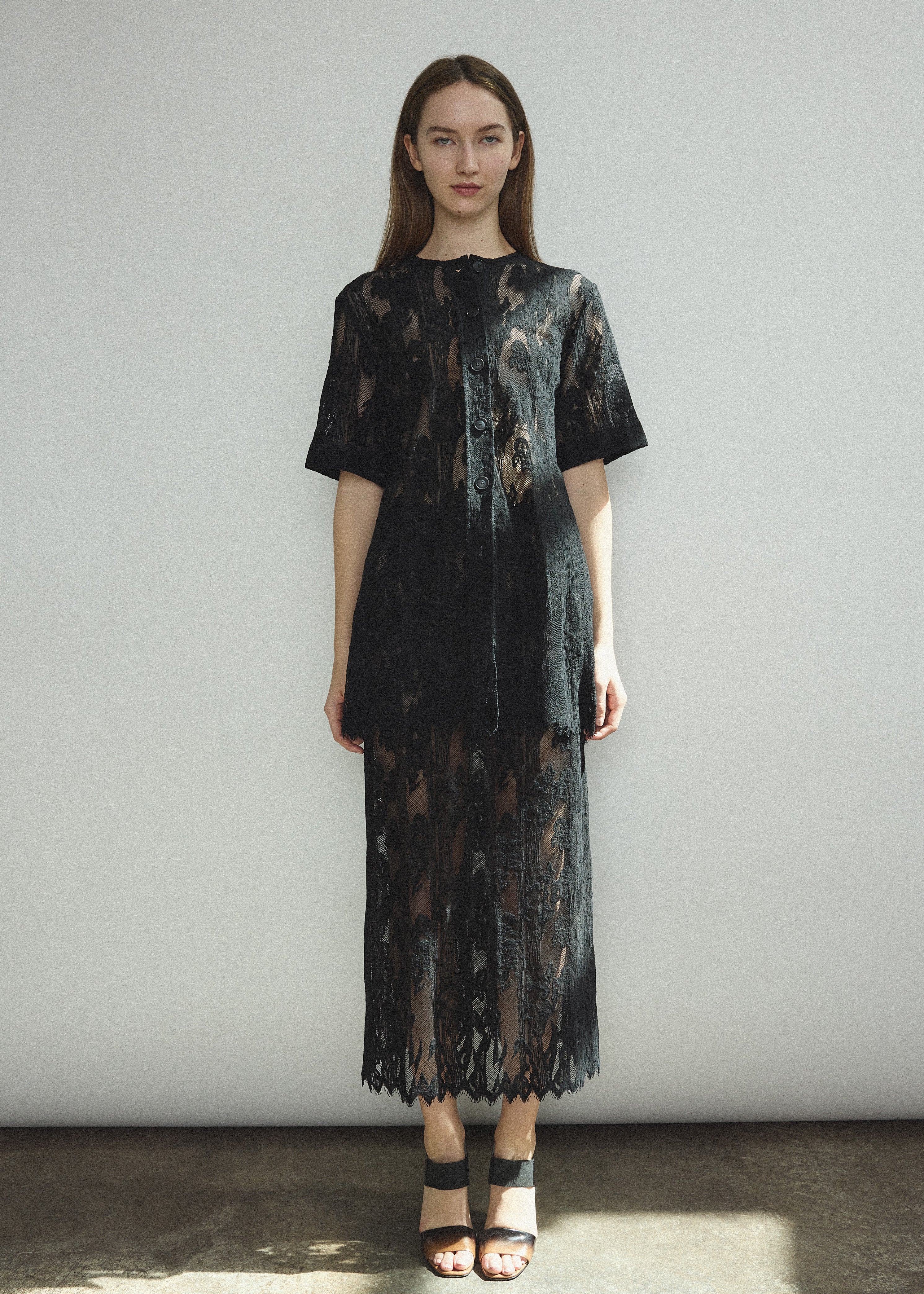 Side view of the black French lace Kamperett Jette Tee styled with the Huene Pant.