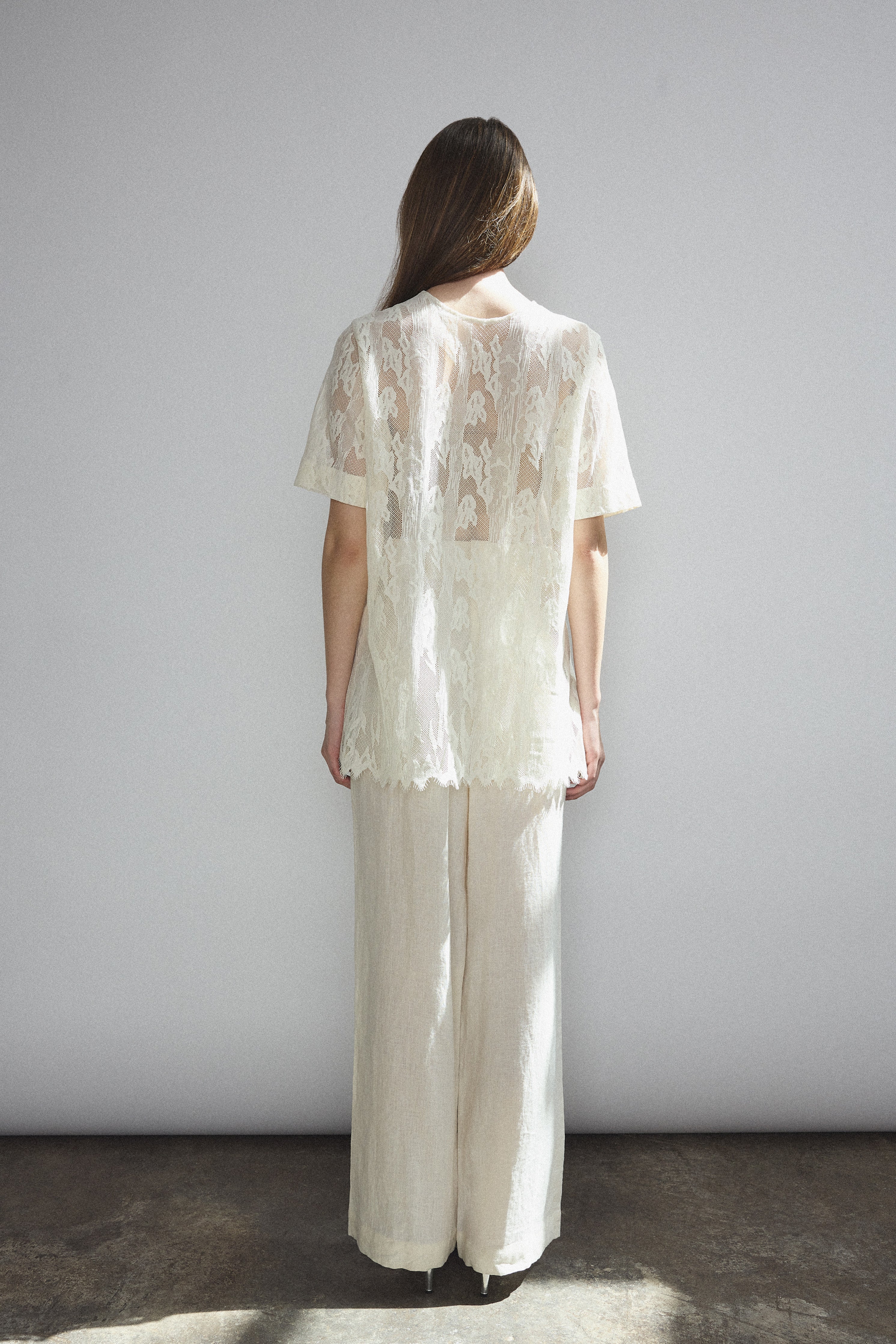 Back view of the cream French lace Kamperett Jette Tee showing the reversible construction with shoulder darts.