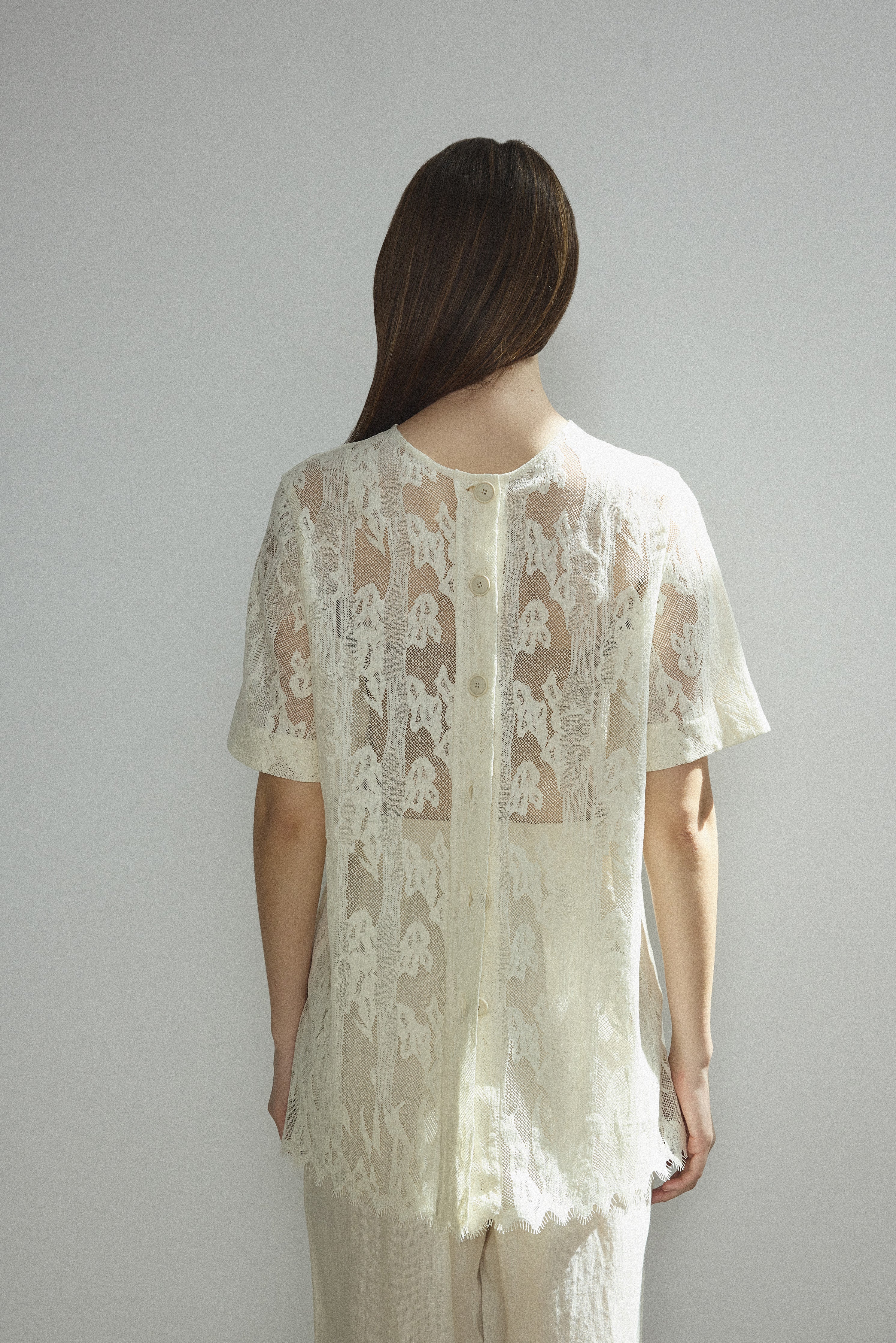 Alternate editorial image of the cream French lace Kamperett Jette Tee.