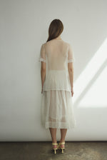 Back view of the alabaster silk organza Kamperett Jette Tee showing the reversible shoulder darts.
