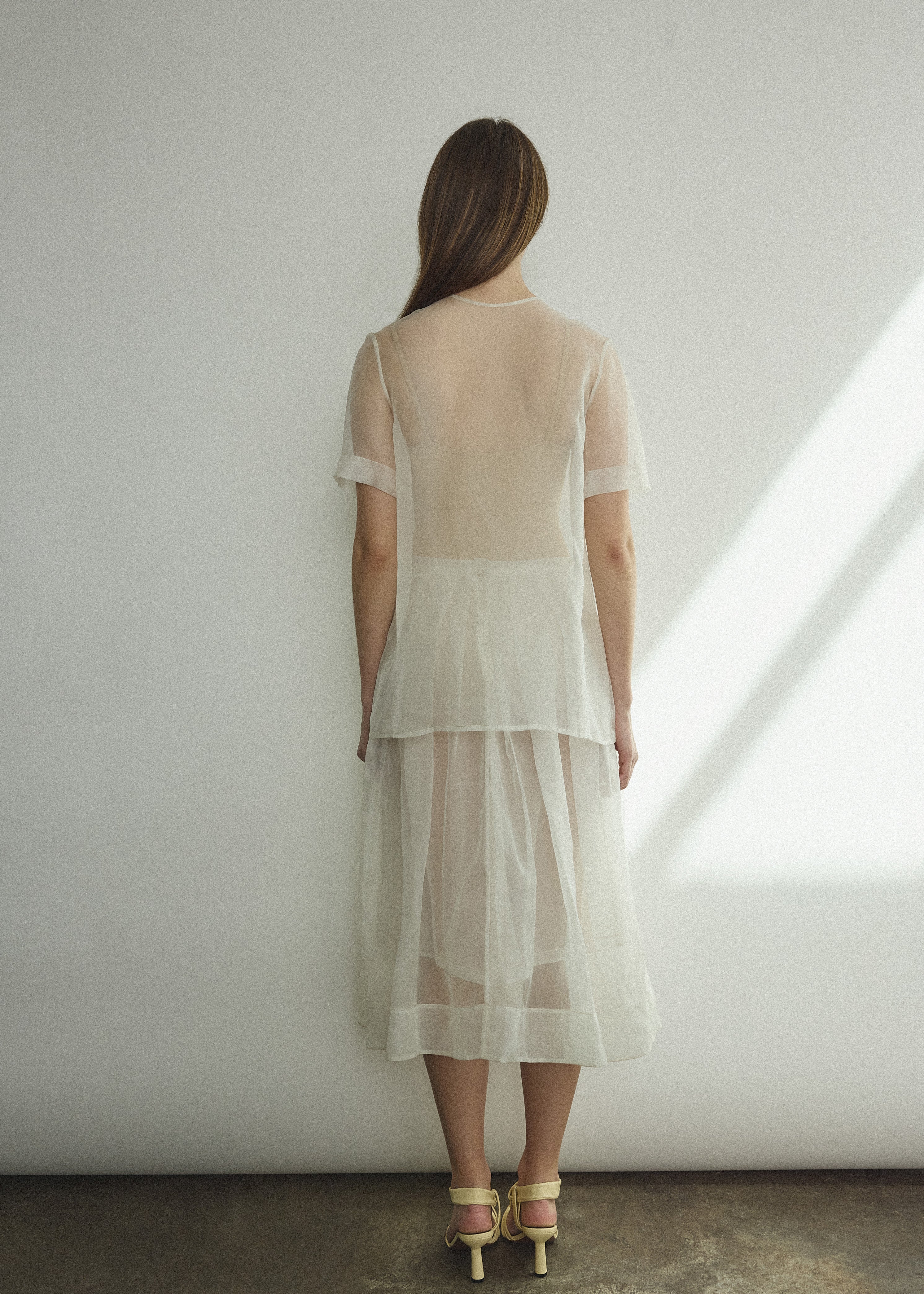 Back view of the alabaster silk organza Kamperett Jette Tee showing the reversible shoulder darts.