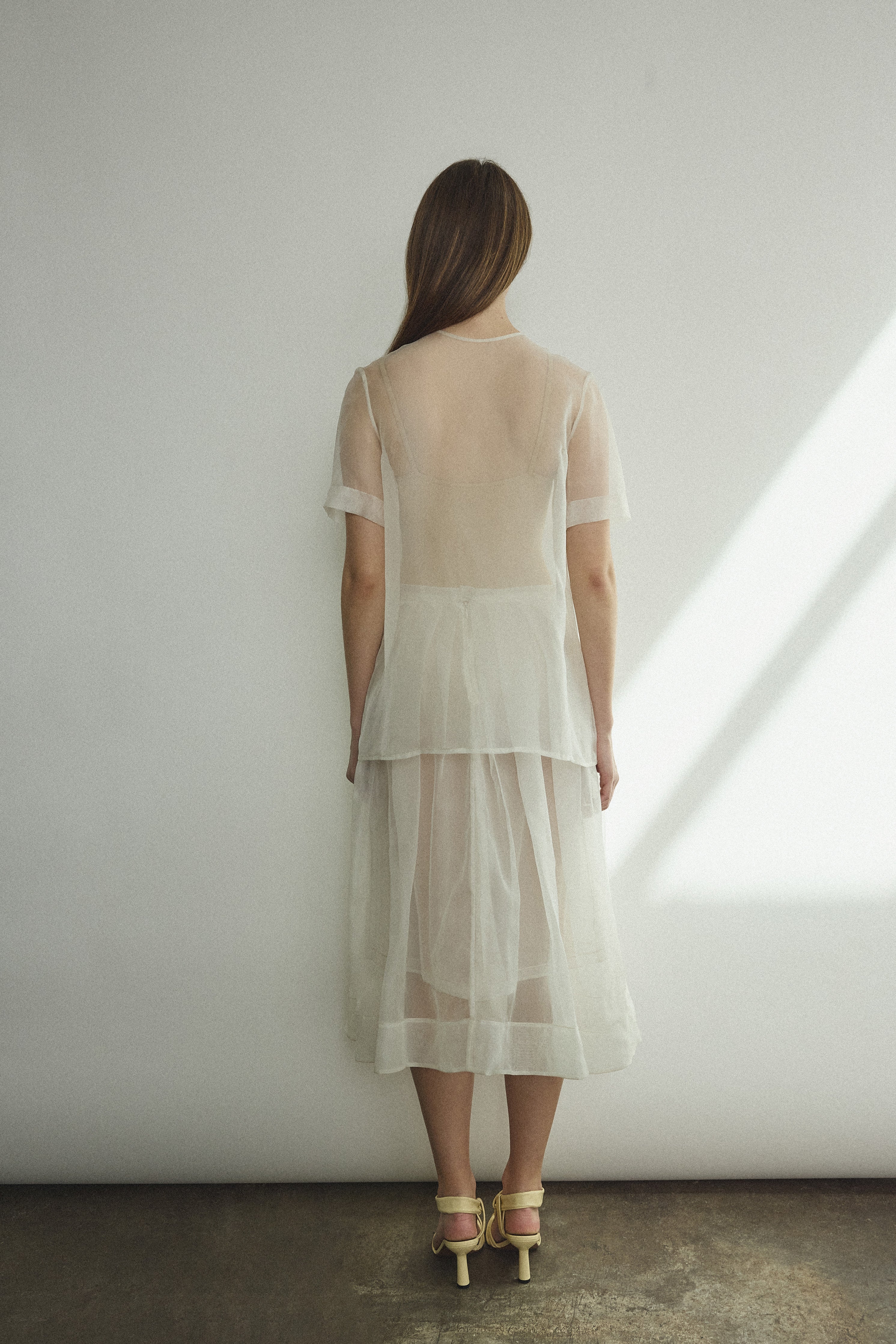 Back view of the alabaster silk organza Kamperett Jette Tee showing the reversible shoulder darts.