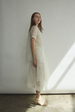 Editorial image of a bride wearing the alabaster silk organza Kamperett Jette Tee.