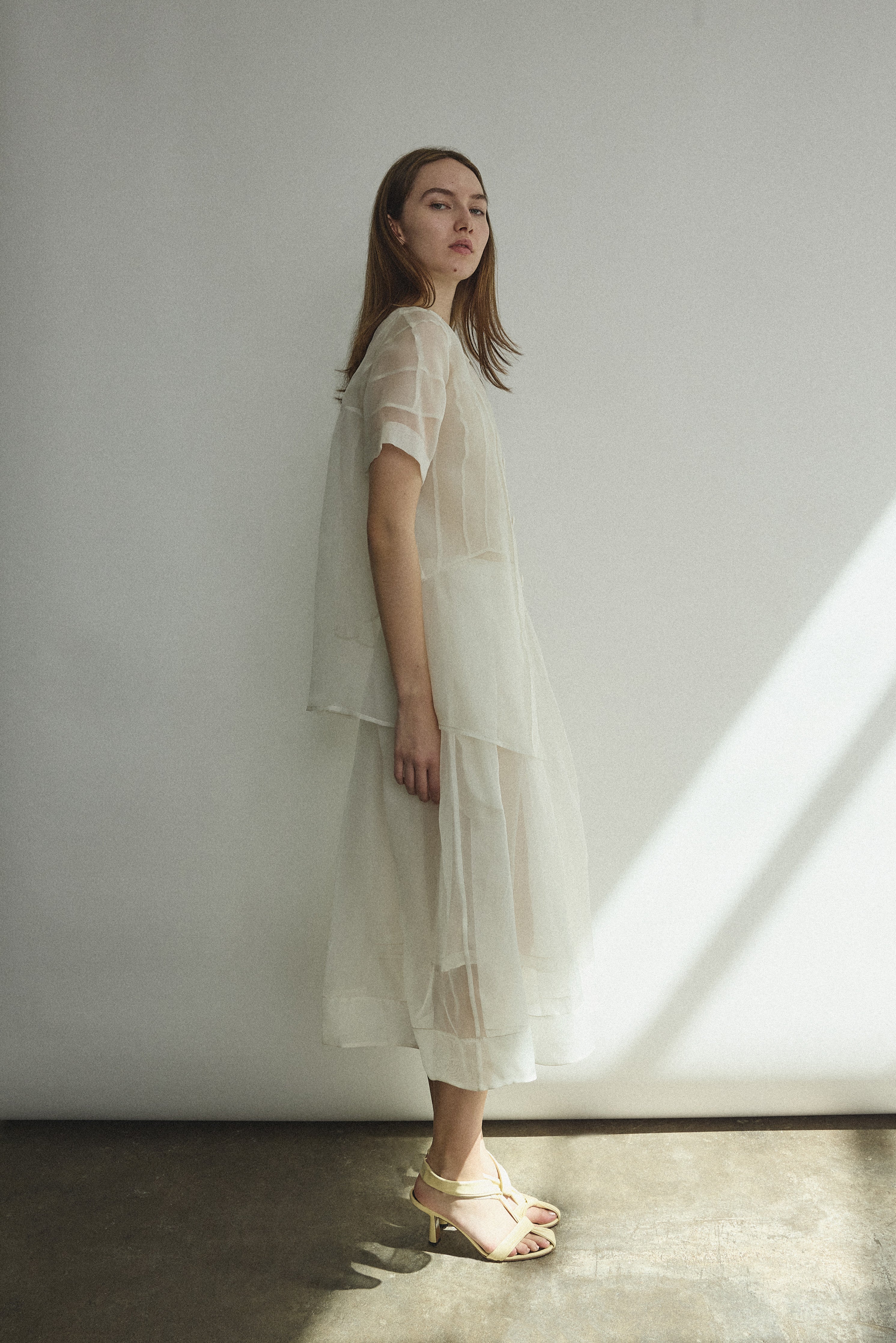 Editorial image of a bride wearing the alabaster silk organza Kamperett Jette Tee.