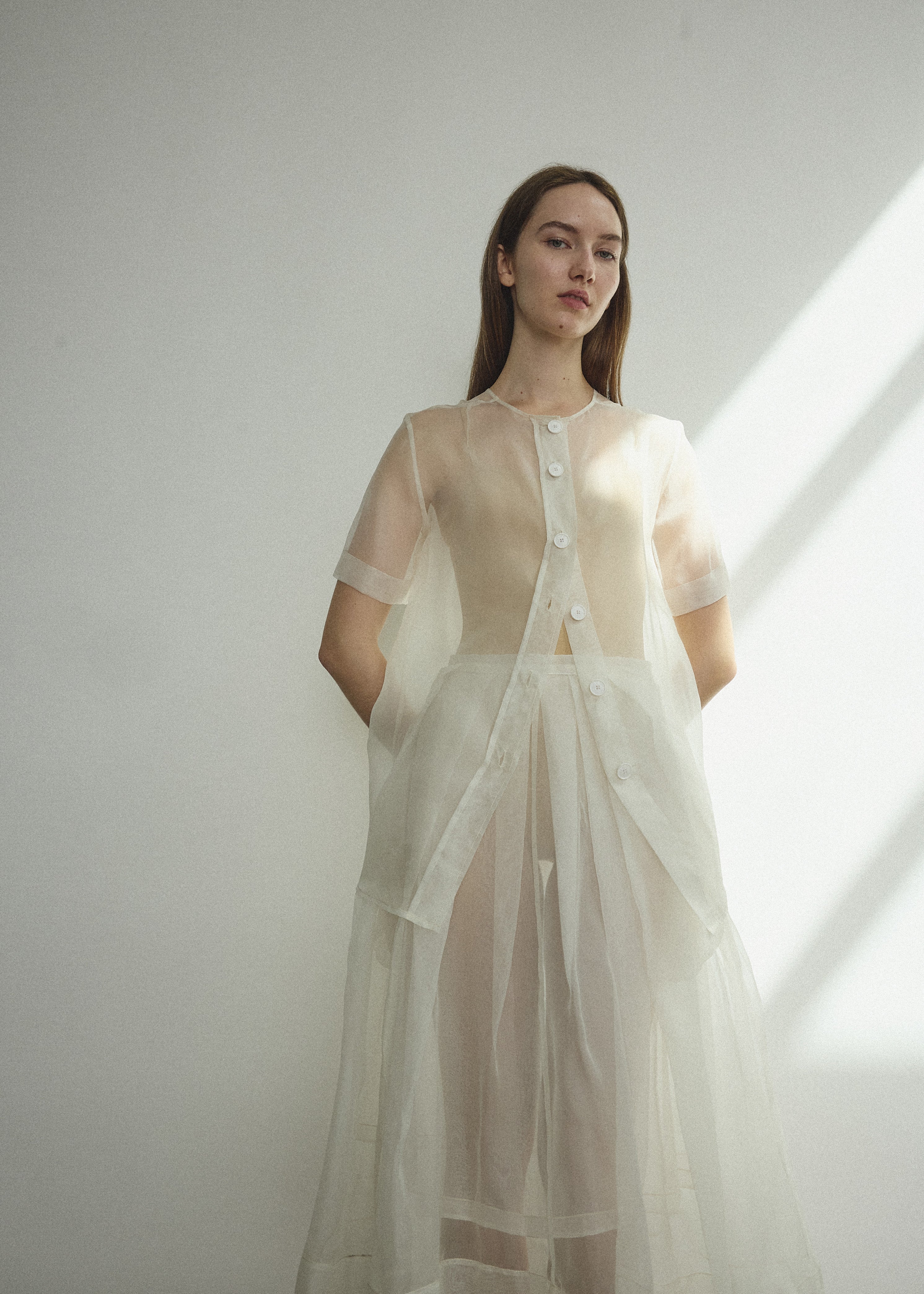 Detail of the wide button placket on the alabaster silk organza Kamperett Jette Tee.