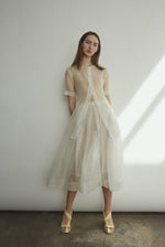 Side view of the alabaster silk organza Kamperett Jette Tee with sheer drape.