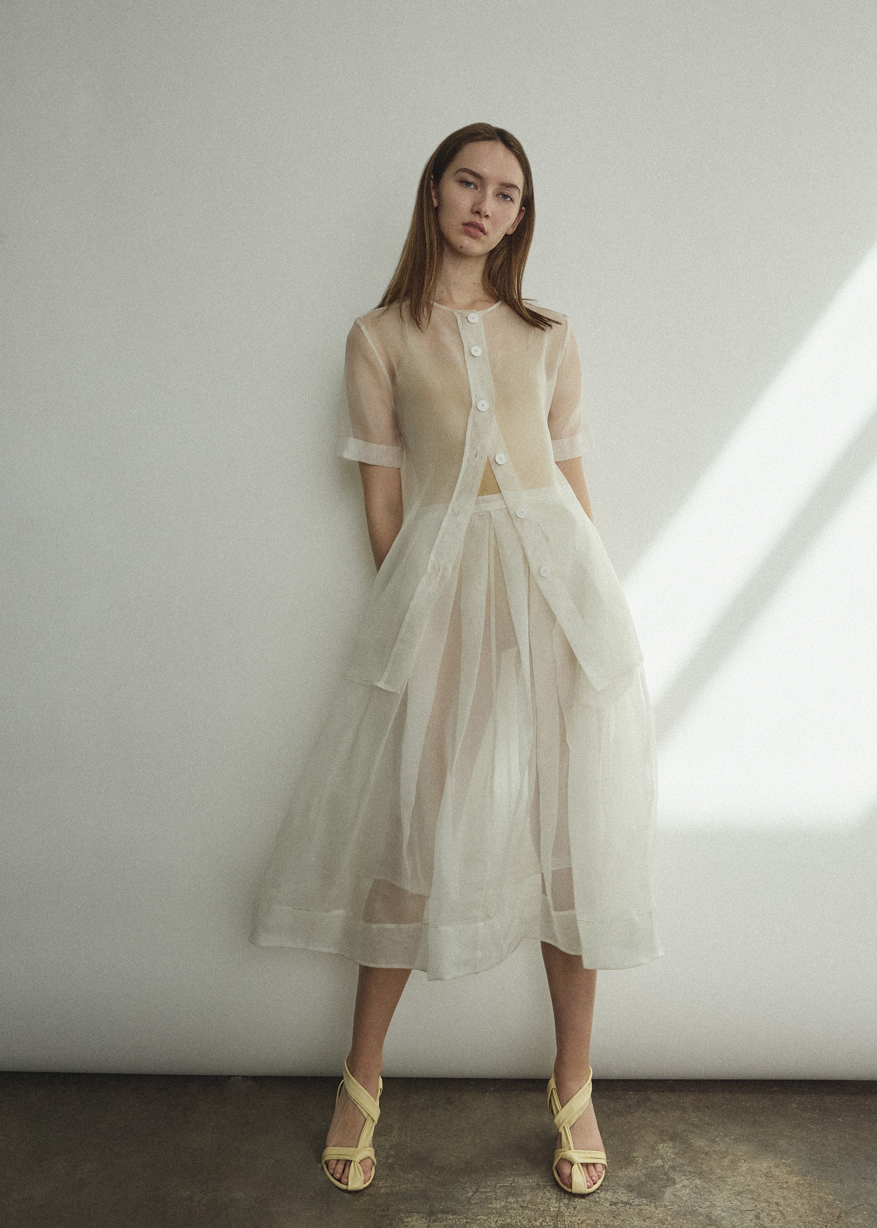 Side view of the alabaster silk organza Kamperett Jette Tee with sheer drape.