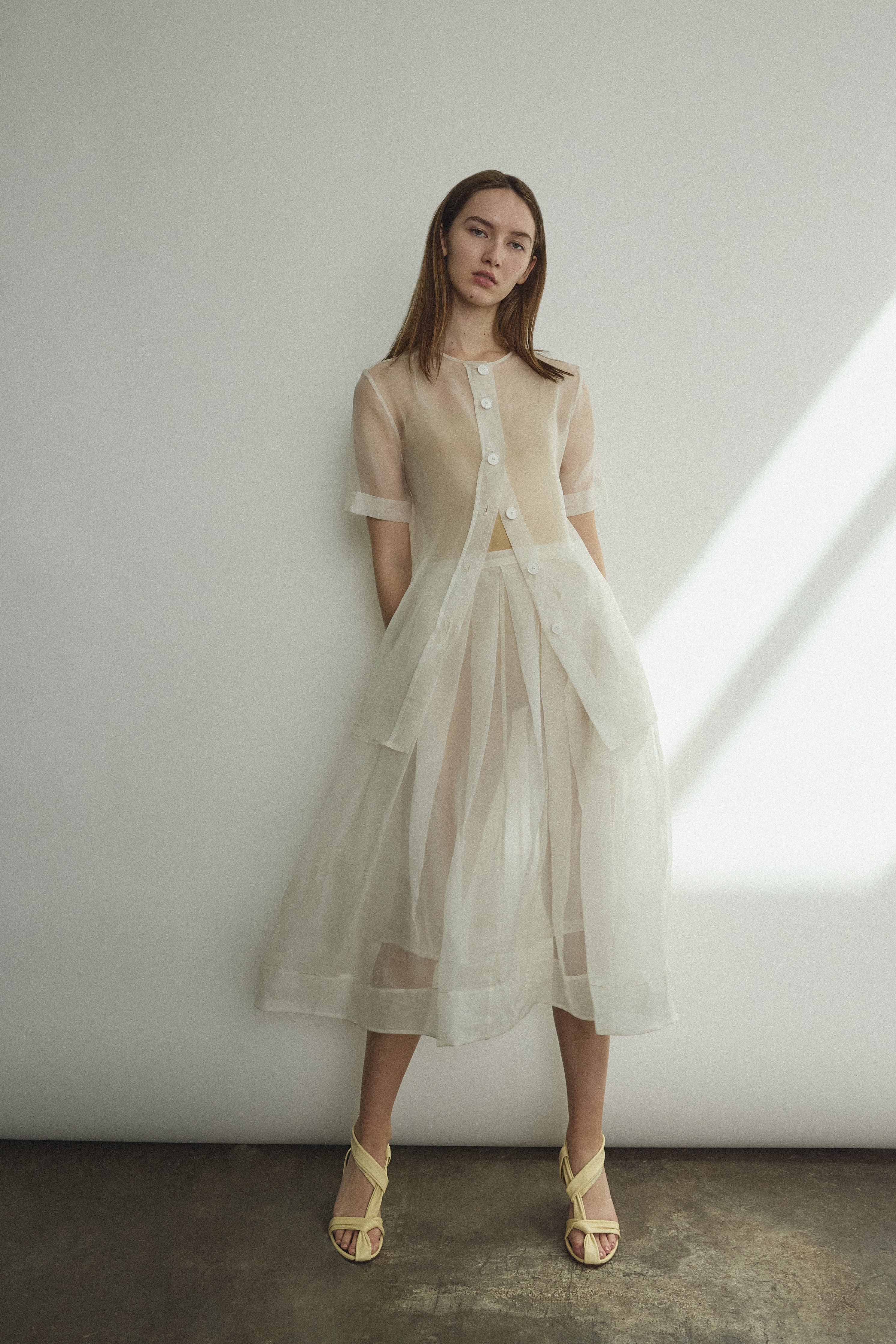 Side view of the alabaster silk organza Kamperett Jette Tee with sheer drape.