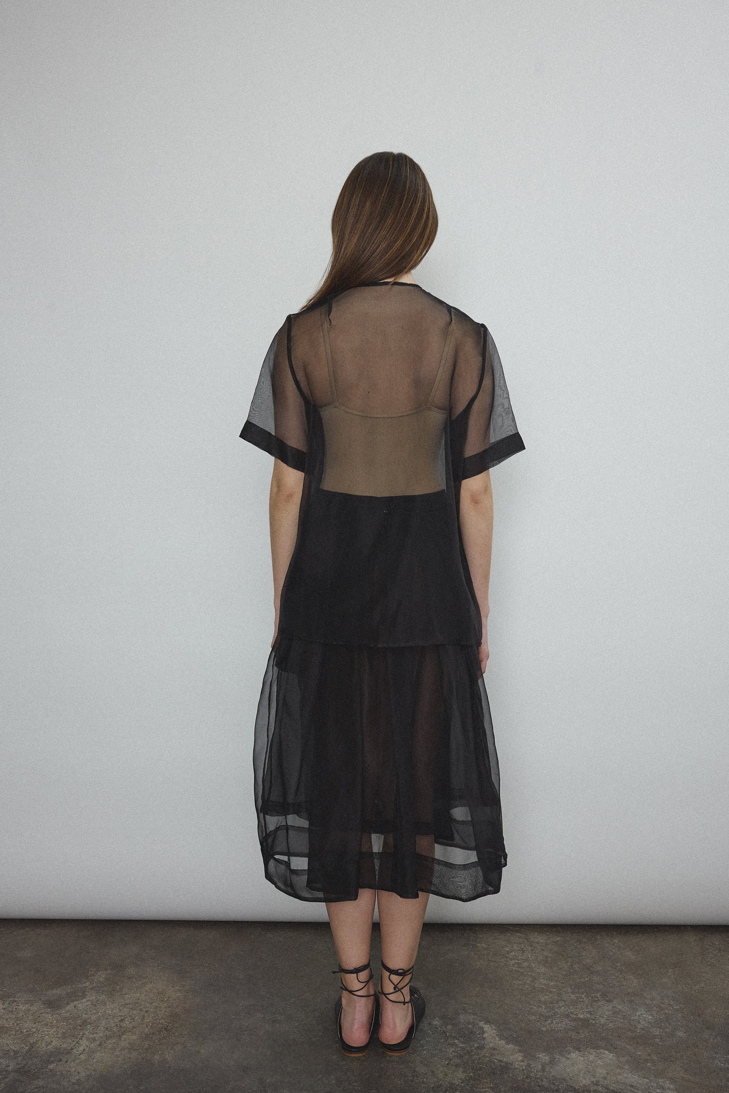 Angled view of the black silk organza Kamperett Jette Tee.