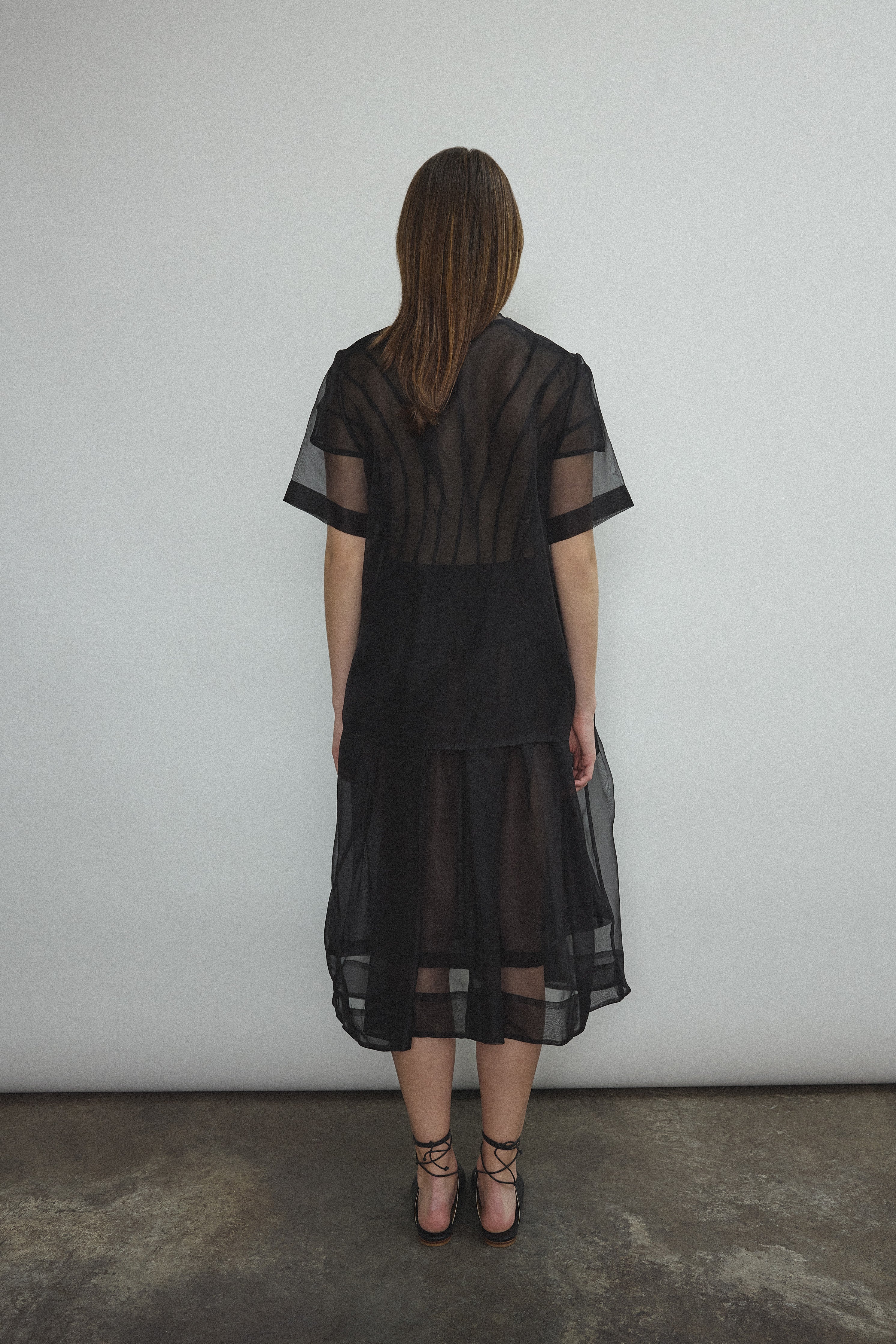 Back view of the black silk organza Kamperett Jette Tee showing the reversible shoulder darts.