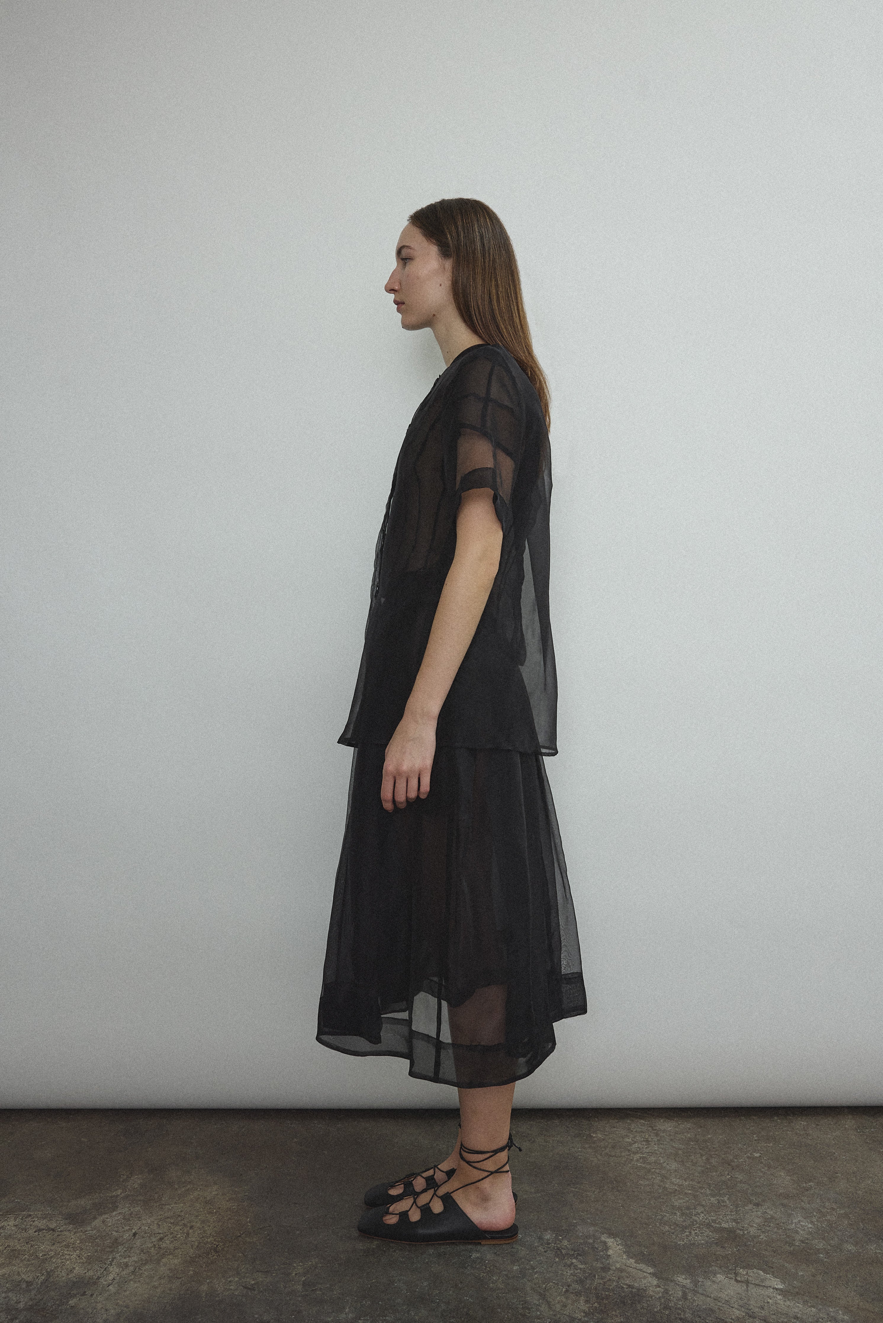 Editorial image of a model in the black silk organza Kamperett Jette Tee.