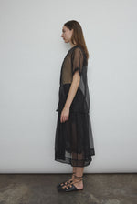Side view of the black silk organza Kamperett Jette Tee with sheer drape.