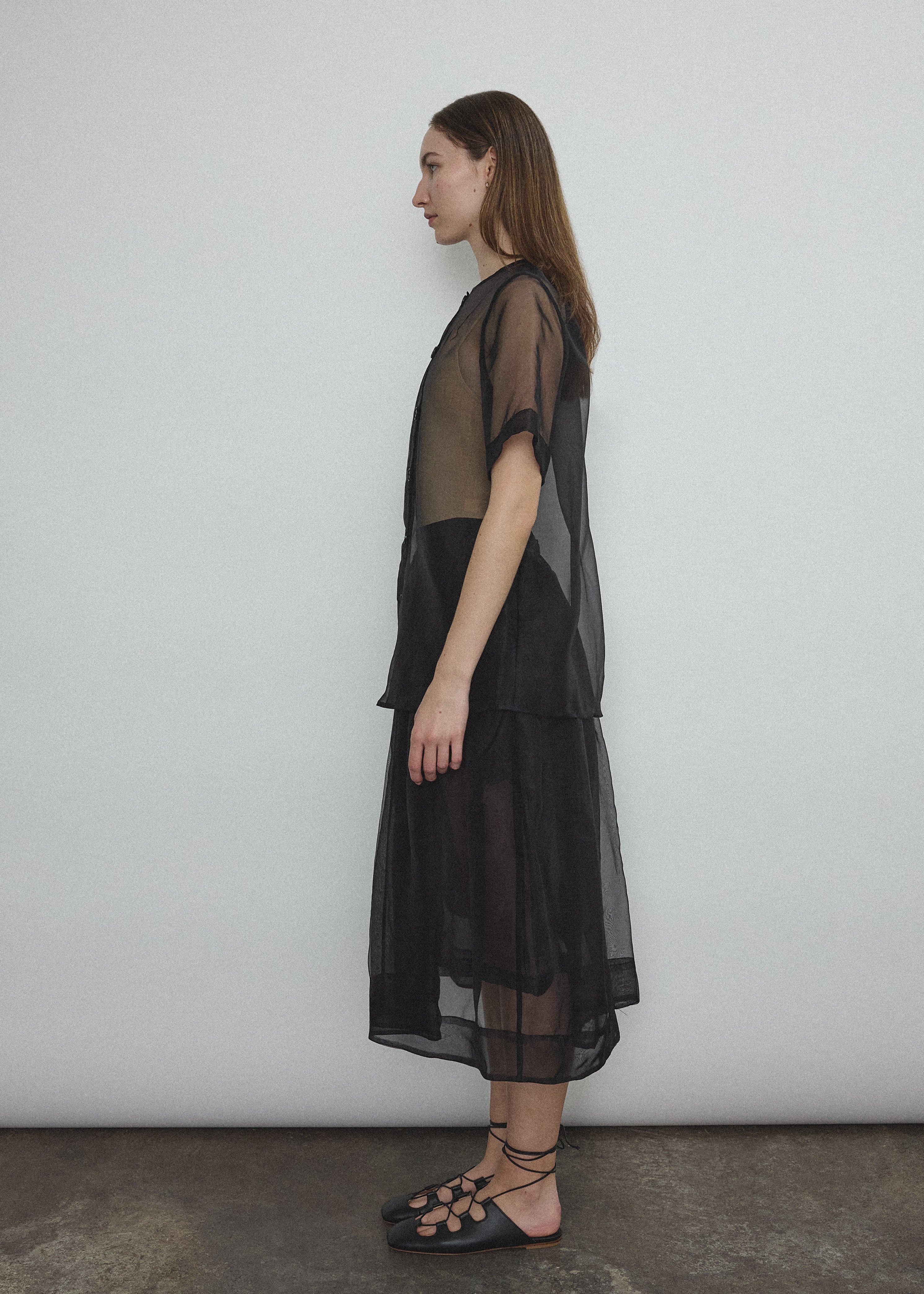 Side view of the black silk organza Kamperett Jette Tee with sheer drape.