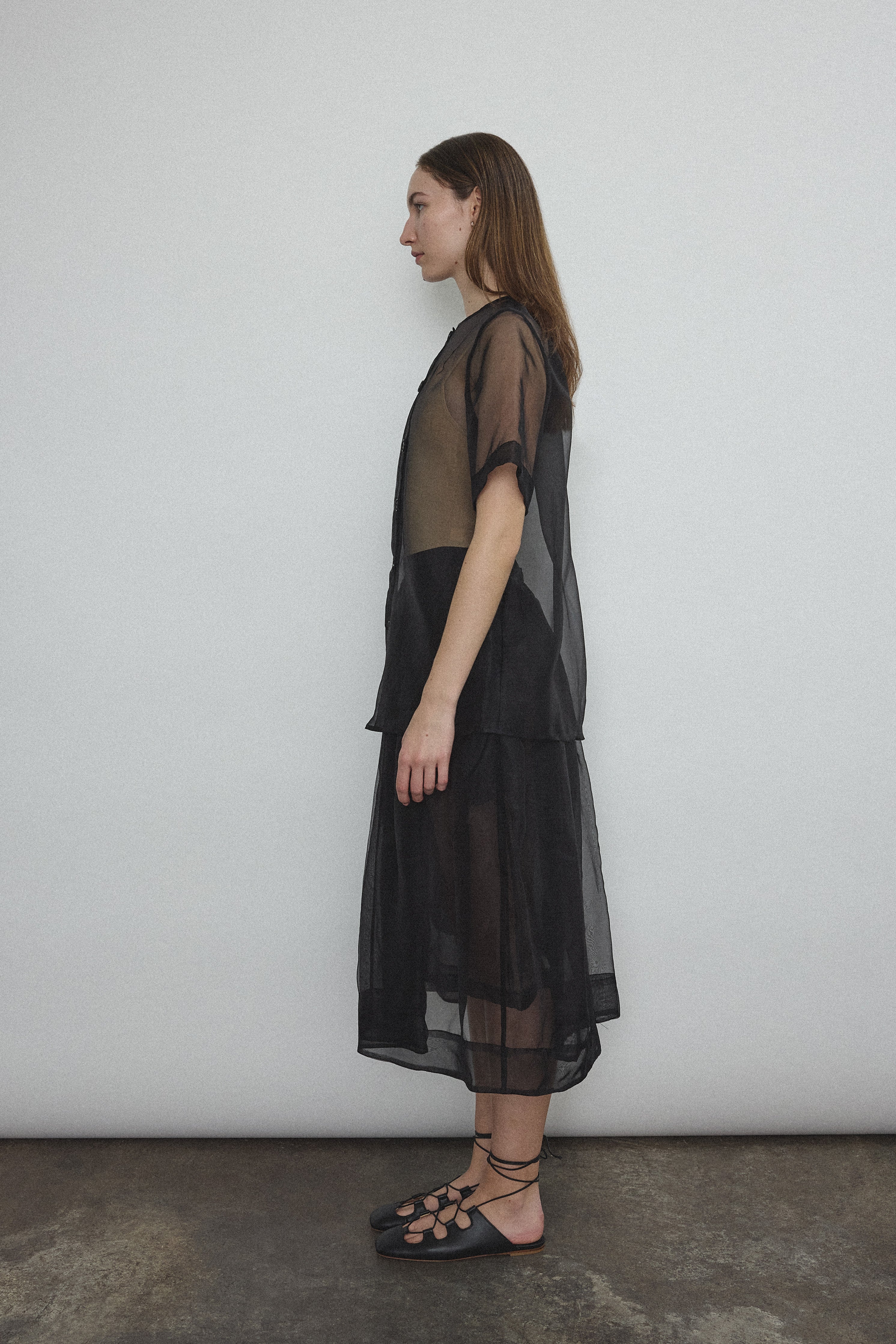 Side view of the black silk organza Kamperett Jette Tee with sheer drape.