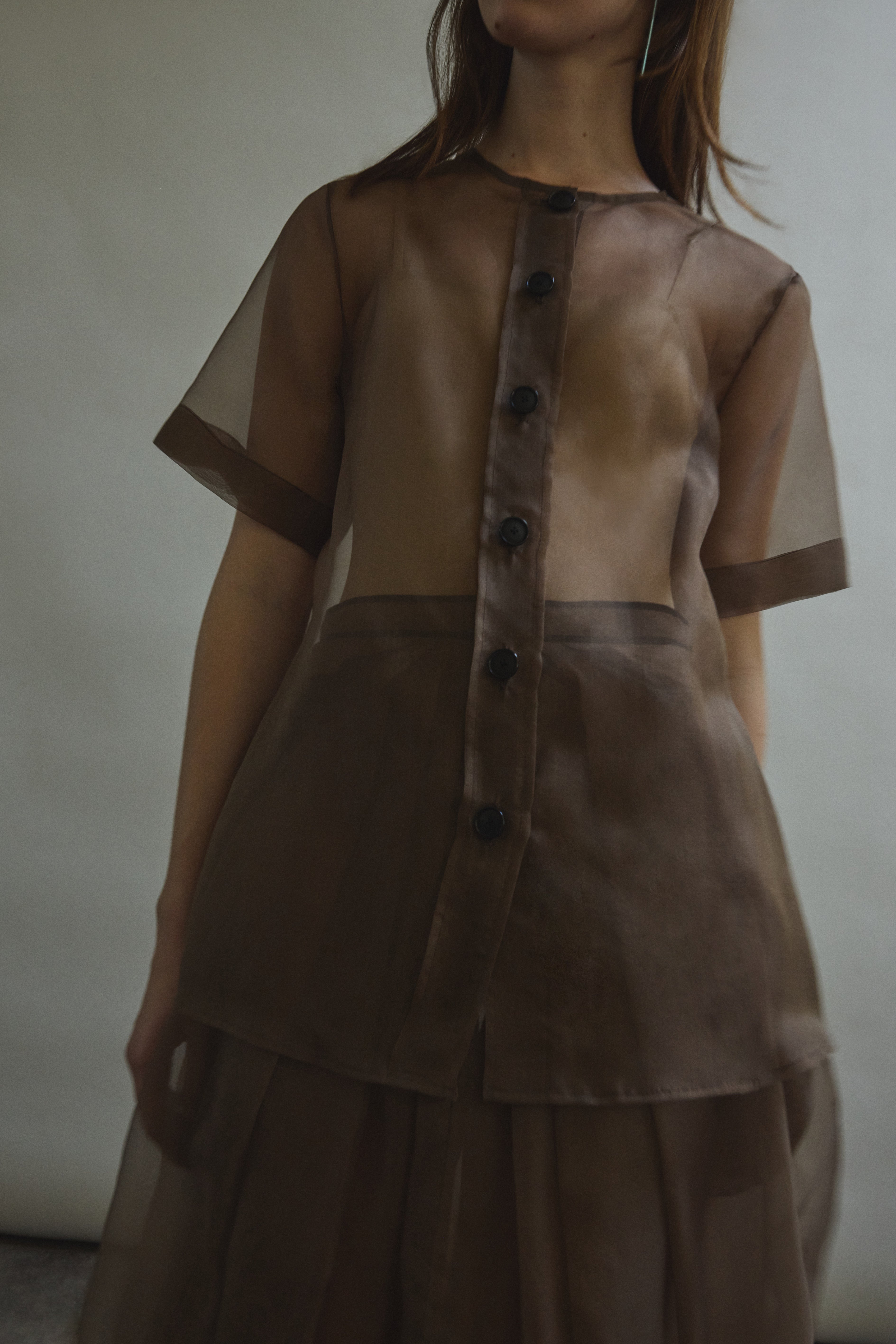 Motion shot of the mushroom silk organza Kamperett Jette Tee, capturing the sheer fluid drape.