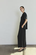 Side view of the black silk crepe Kamperett Jette Silk Crepe Tee showing the relaxed oversized silhouette.