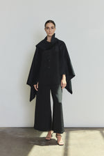 Front view of a model wearing the black Italian cashmere Kamperett Joan Cape, styled with the Jette Silk Crepe Tee and Alix Silk Crepe Pant.