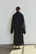 Model wearing the black Kamperett Joan Cashmere Cape styled with the Alix Silk Crepe Pant in Black.
