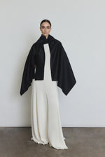 Bride wearing the black Kamperett Joan Cashmere Cape draped over the Ray Gown in Alabaster.