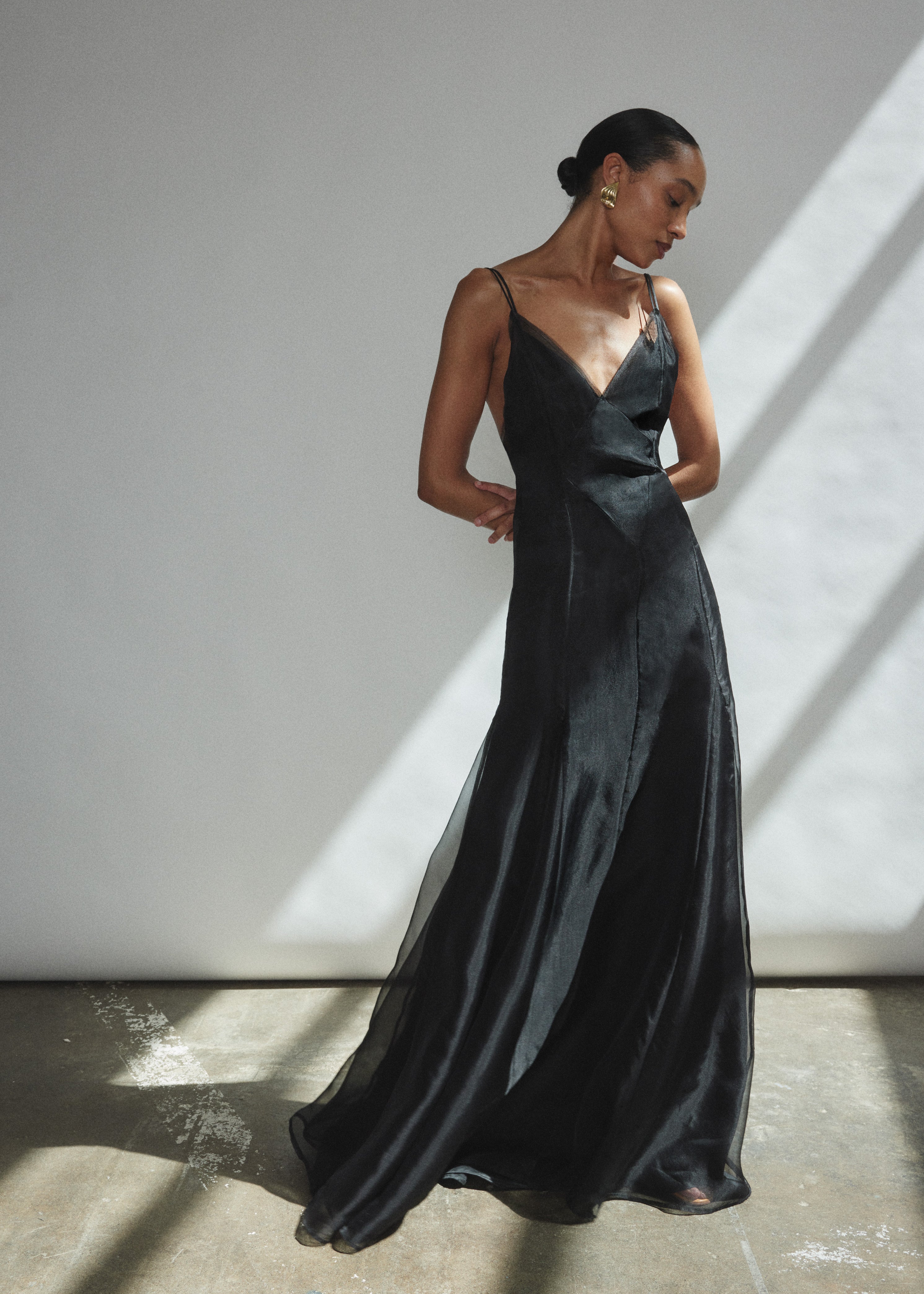Angled view of the black silk organza Kamperett Lalique Gown with intricately seamed sheer construction.