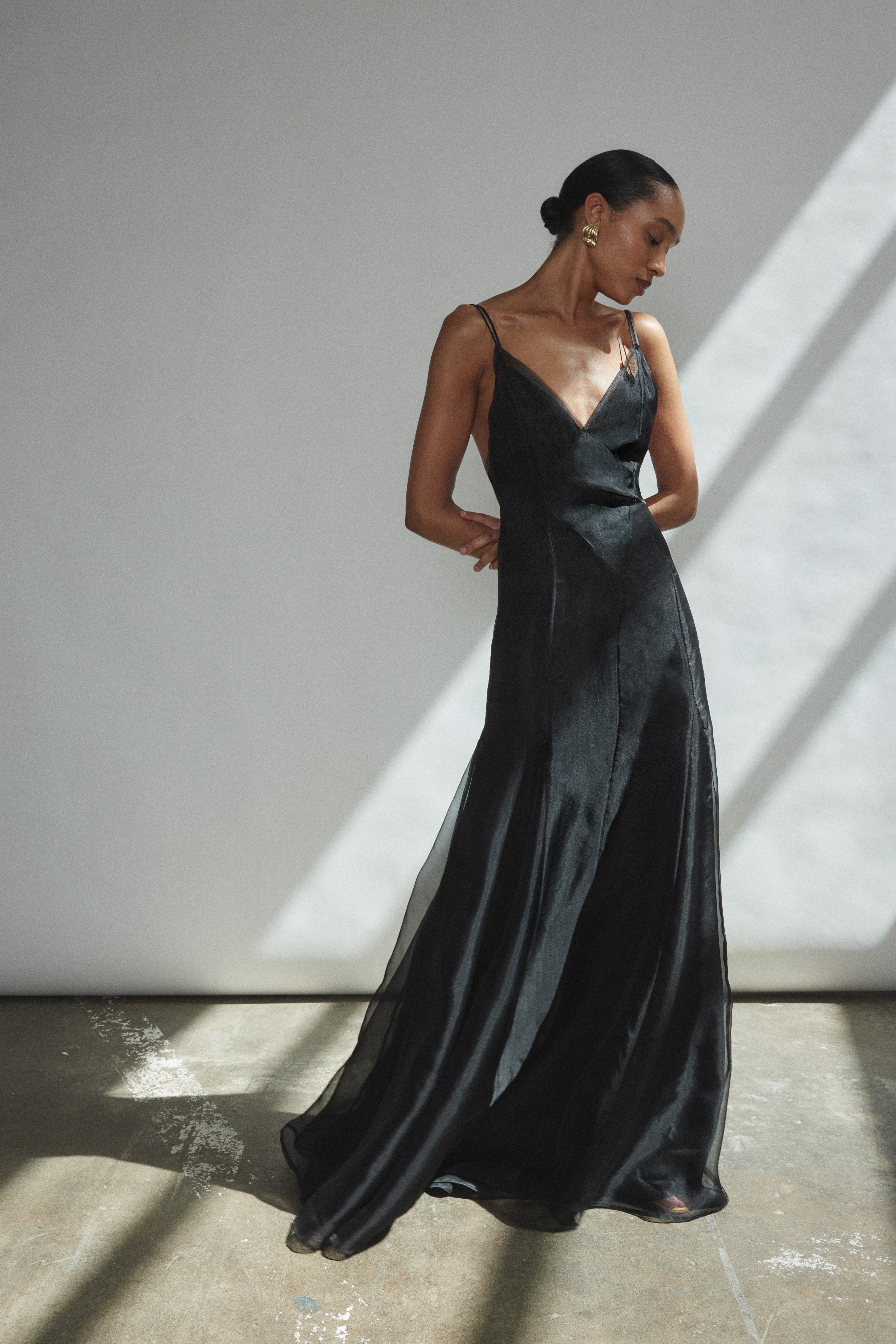 Angled view of the black silk organza Kamperett Lalique Gown with intricately seamed sheer construction.