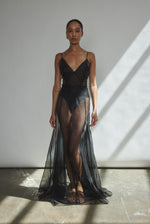 Motion shot of the black silk organza Kamperett Lalique Gown, capturing the sweeping godet skirt.