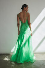 Front view of a model wearing the celadon silk organza Kamperett Lalique Gown, a sheer V-neck maxi with multi-godet skirt and corded straps.