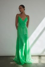 Side view of the celadon silk organza Kamperett Lalique Gown showing the sheer drape and multi-godet skirt.