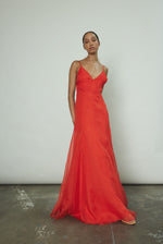 Model wearing the vermilion Kamperett Lalique Gown layered over the Simone Slip Dress.