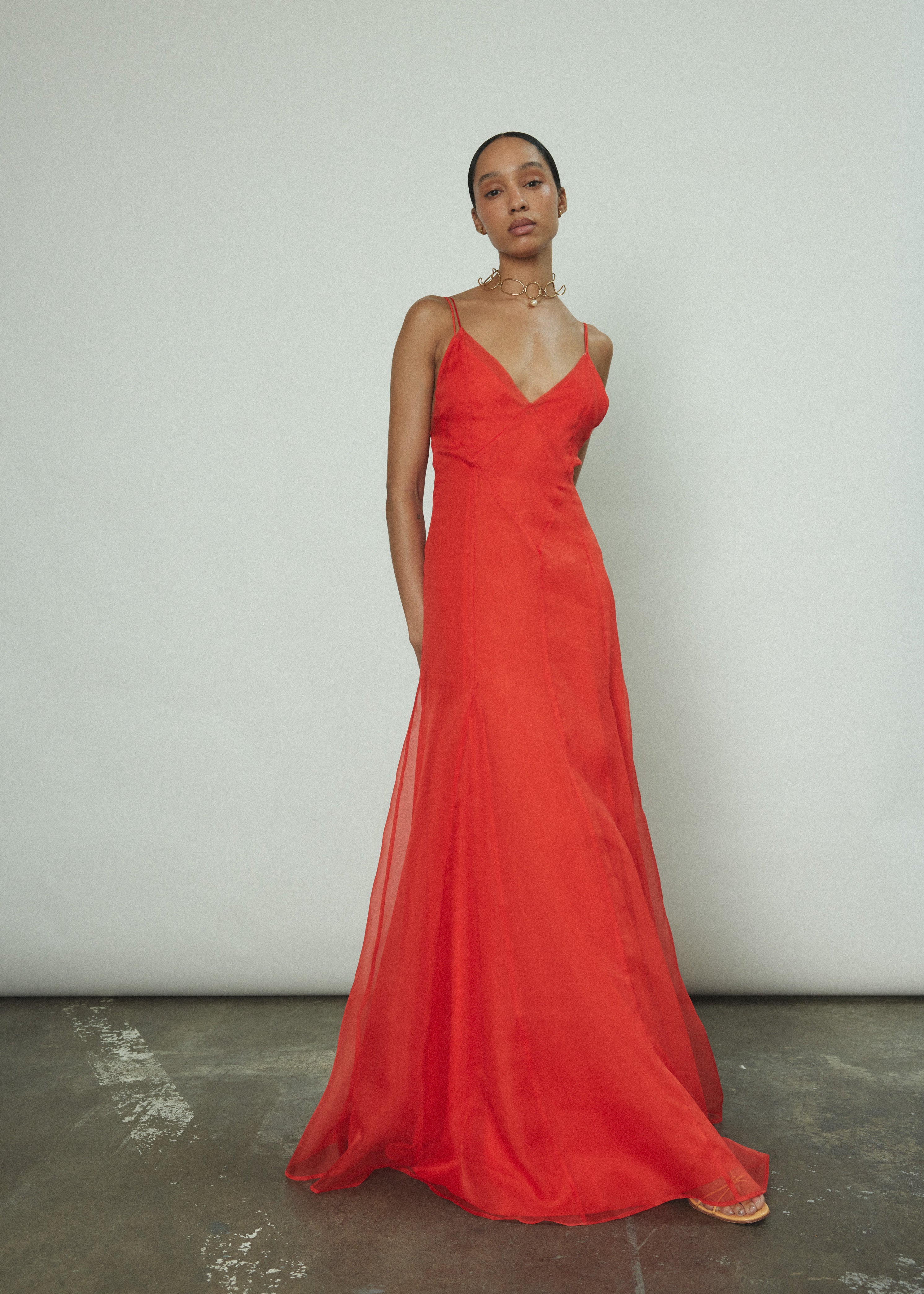 Model wearing the vermilion Kamperett Lalique Gown layered over the Simone Slip Dress.