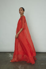 The vermilion Kamperett Lalique Gown styled over the Thea Sheath Dress for a layered occasion look.