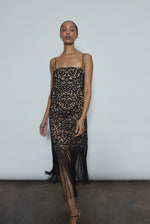 Detail of the intricately cut openwork cotton motif and hand-applied fringe on the black Kamperett Lenore Dress.