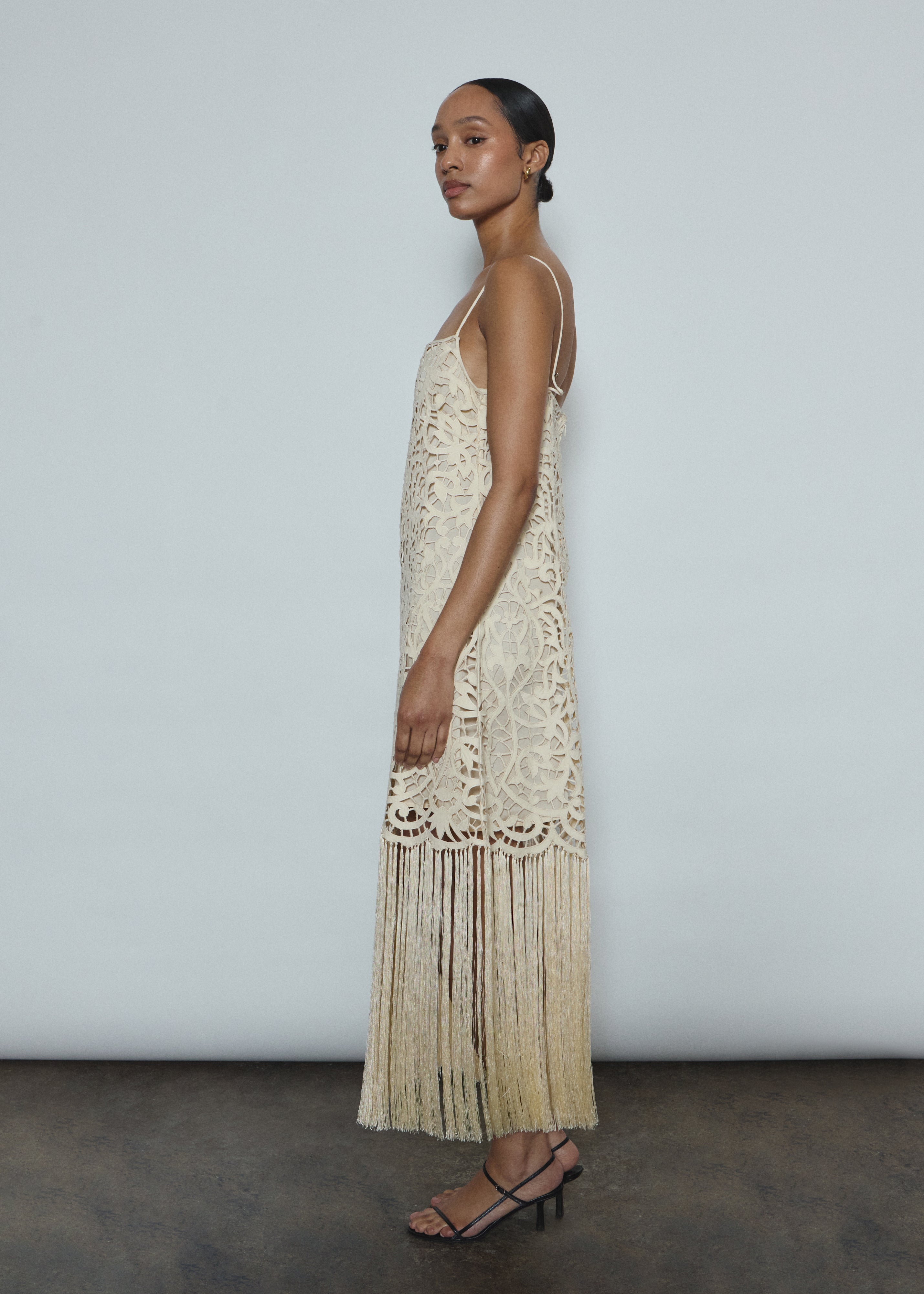Back view of the cream cotton openwork Kamperett Lenore Dress with invisible center-back zip and spaghetti straps.