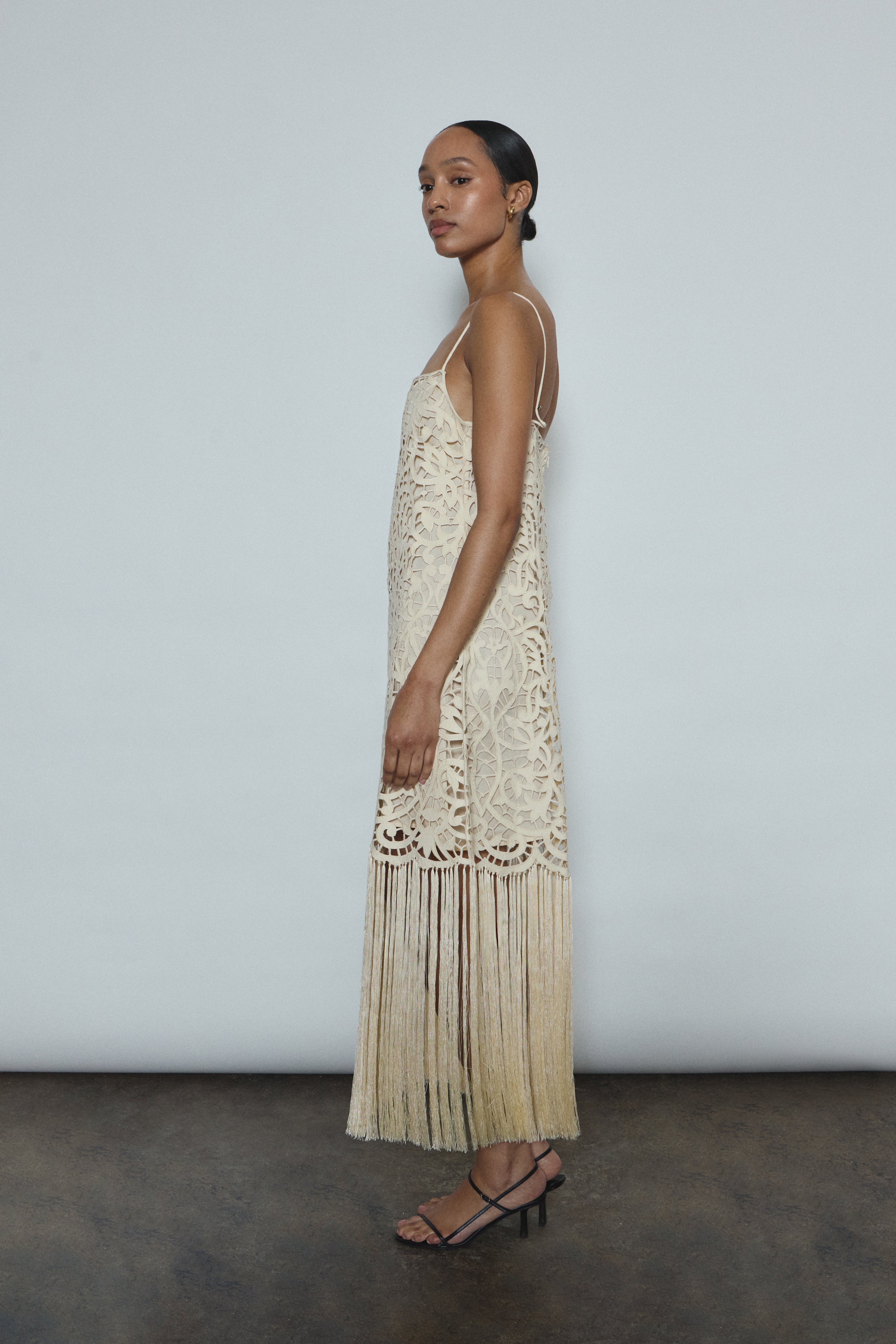 Back view of the cream cotton openwork Kamperett Lenore Dress with invisible center-back zip and spaghetti straps.