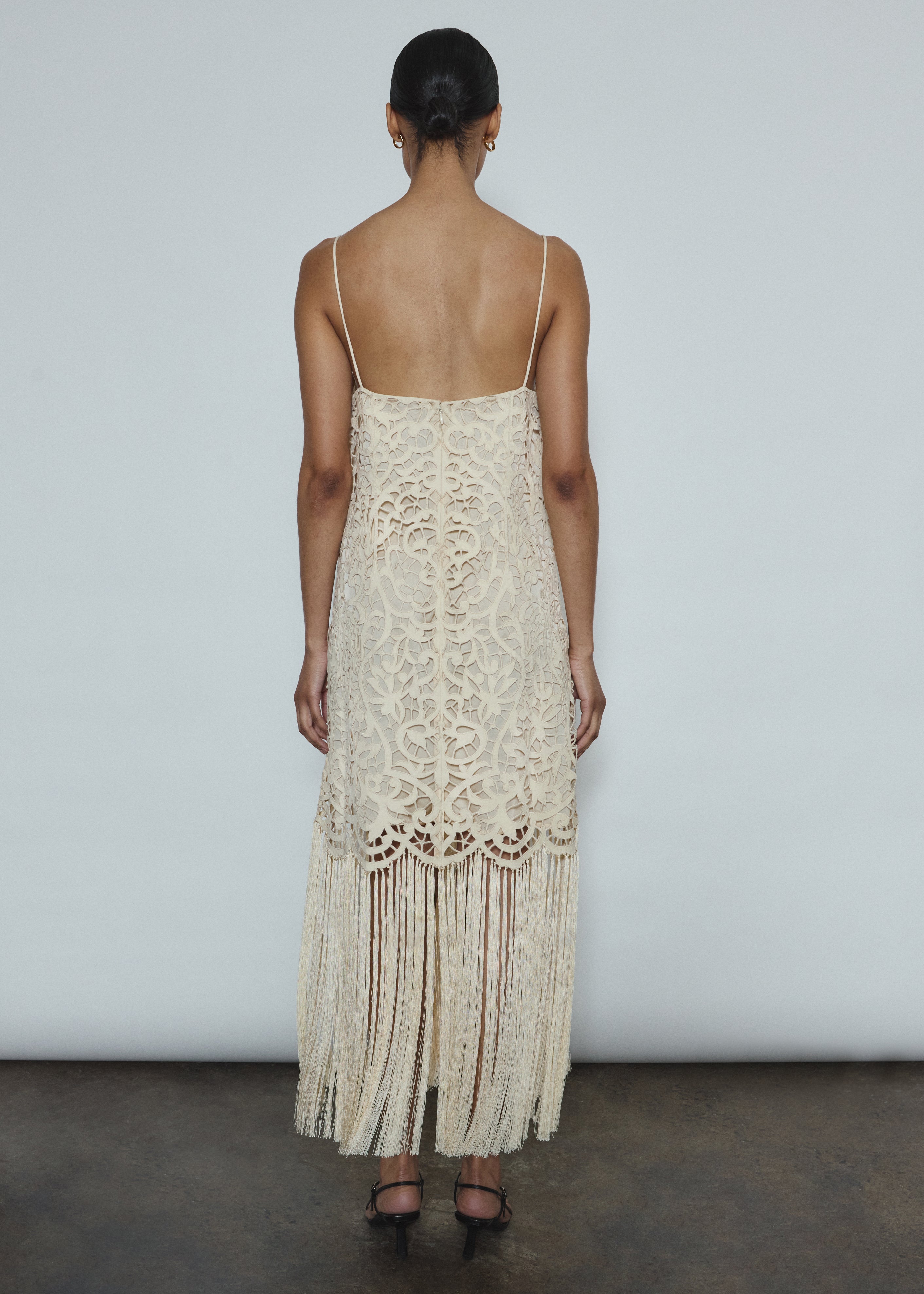 Editorial image of a bride wearing the cream Kamperett Lenore Dress, a modern bridal A-line midi with openwork motif.
