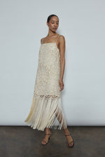 Side view of the cream cotton openwork Kamperett Lenore Dress showing the A-line silhouette and fringe-trimmed hem.