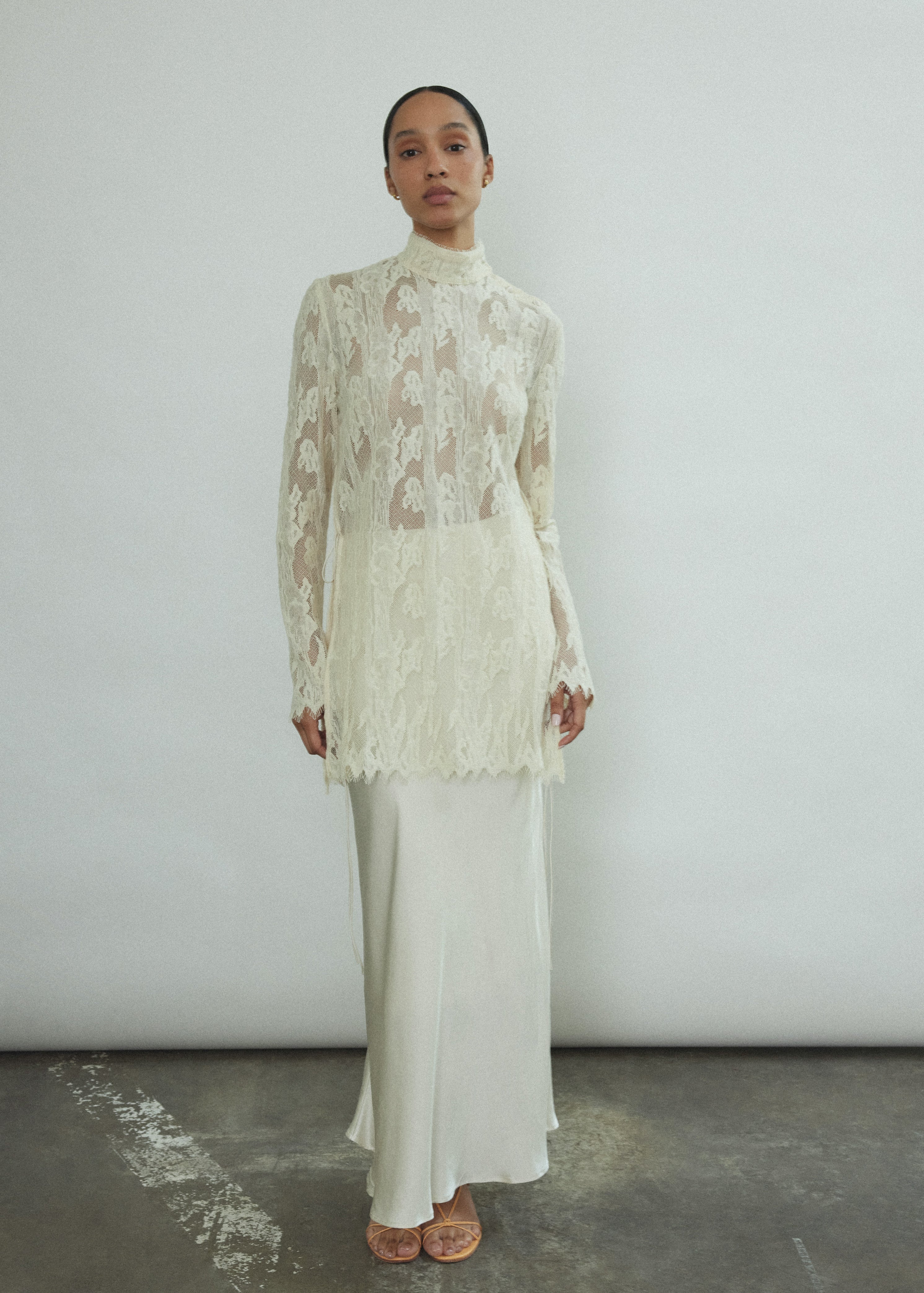 Side view of the ivory silk charmeuse Kamperett Leona Skirt with bias-cut drape and side zip closure.