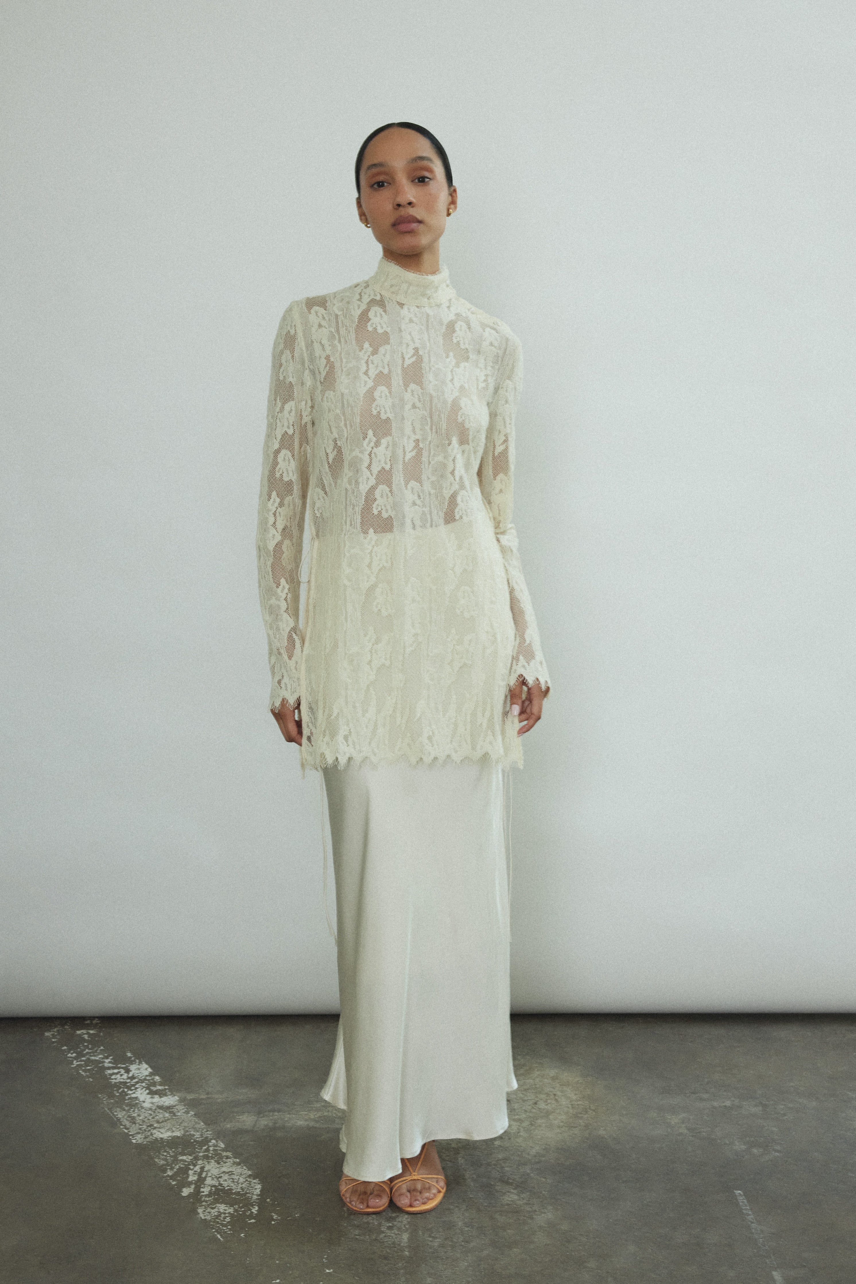 Side view of the ivory silk charmeuse Kamperett Leona Skirt with bias-cut drape and side zip closure.
