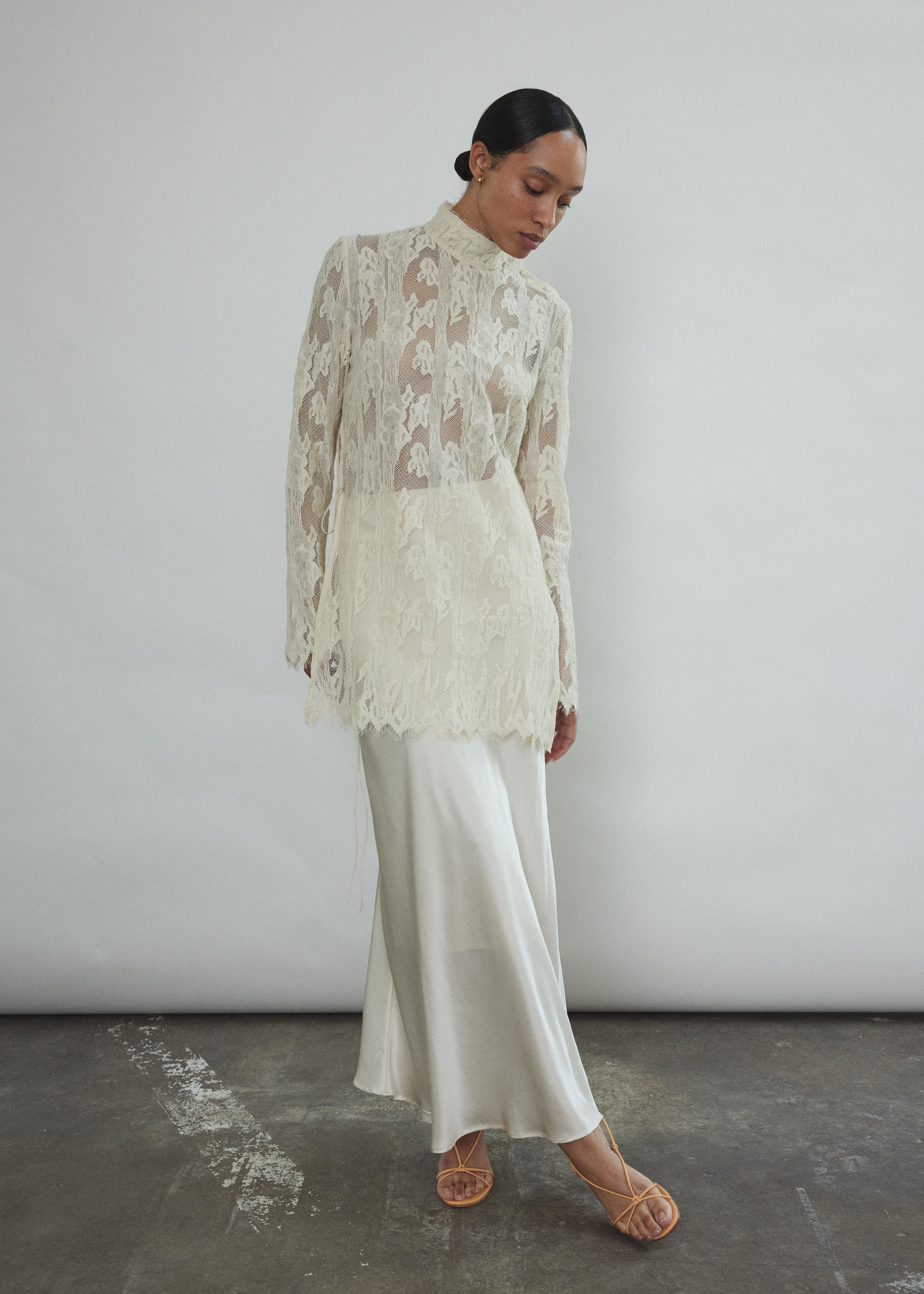 Front view of a bride wearing the ivory silk charmeuse Kamperett Leona Skirt layered under the Camille Midi Dress.