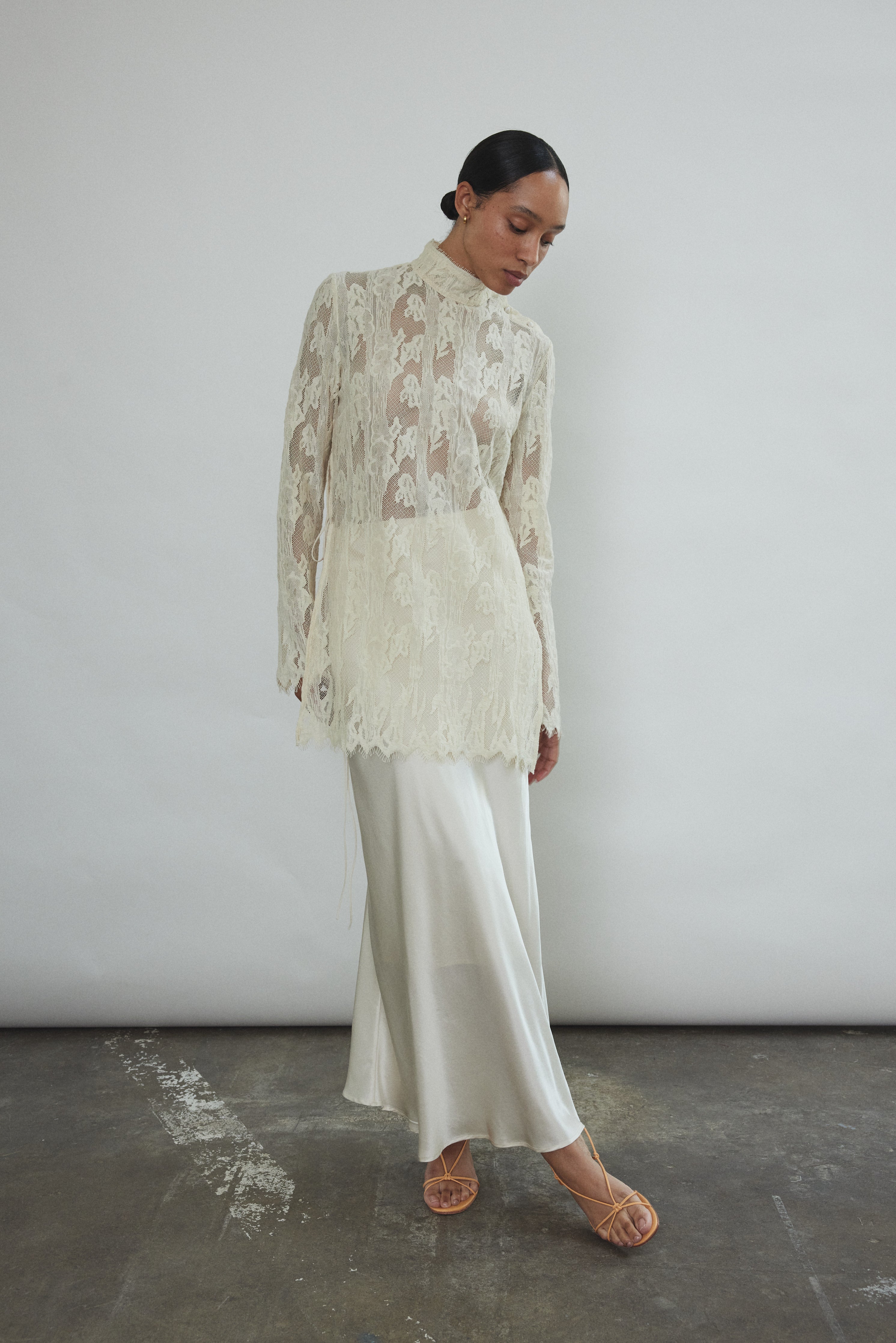 Front view of a bride wearing the ivory silk charmeuse Kamperett Leona Skirt layered under the Camille Midi Dress.