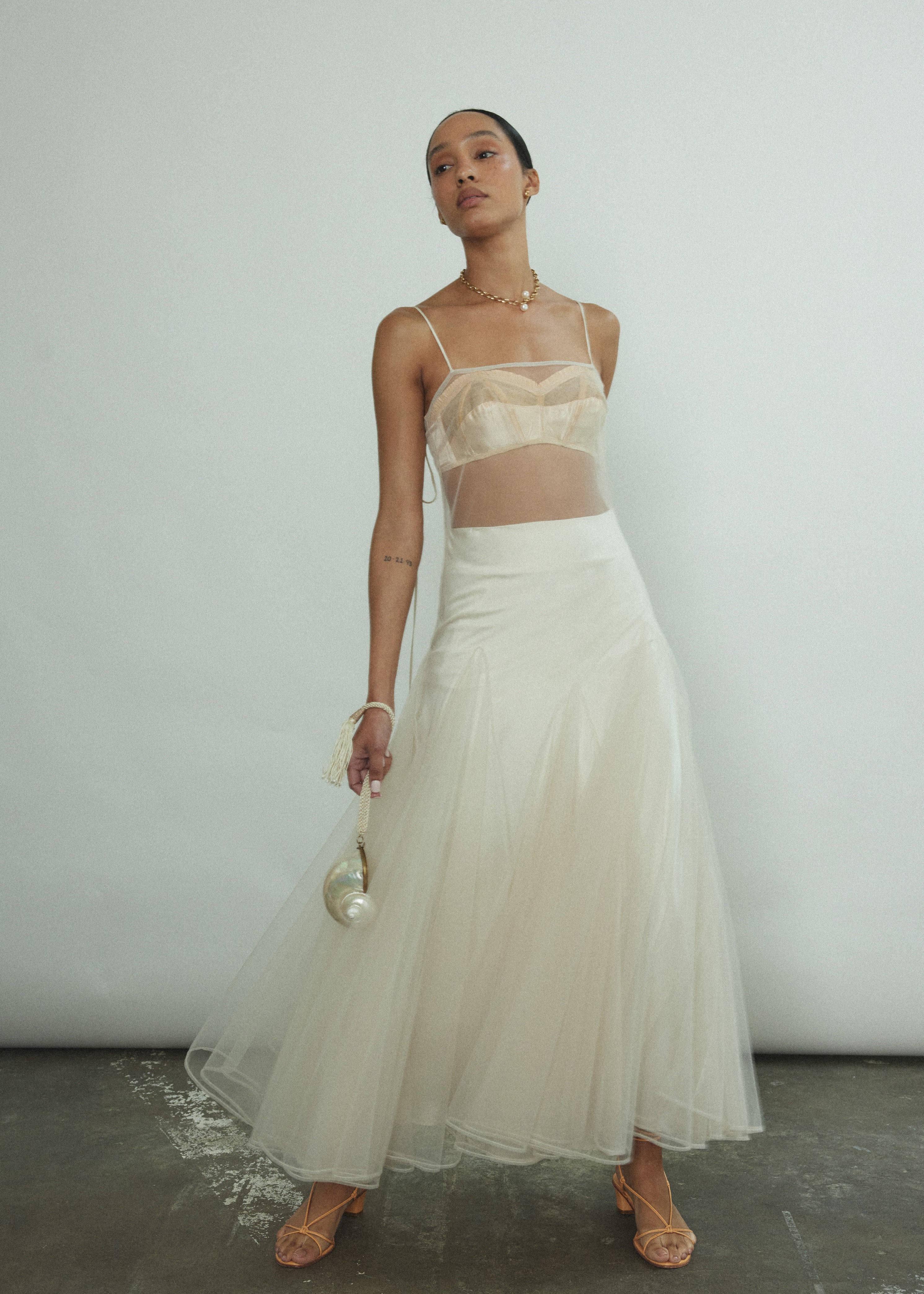 Styled view of the ivory silk charmeuse Kamperett Leona Skirt paired with the Isabella Tunic.
