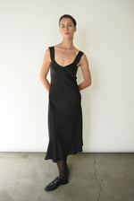 Editorial image of the black silk charmeuse Kamperett Lisette Midi Slip Dress.