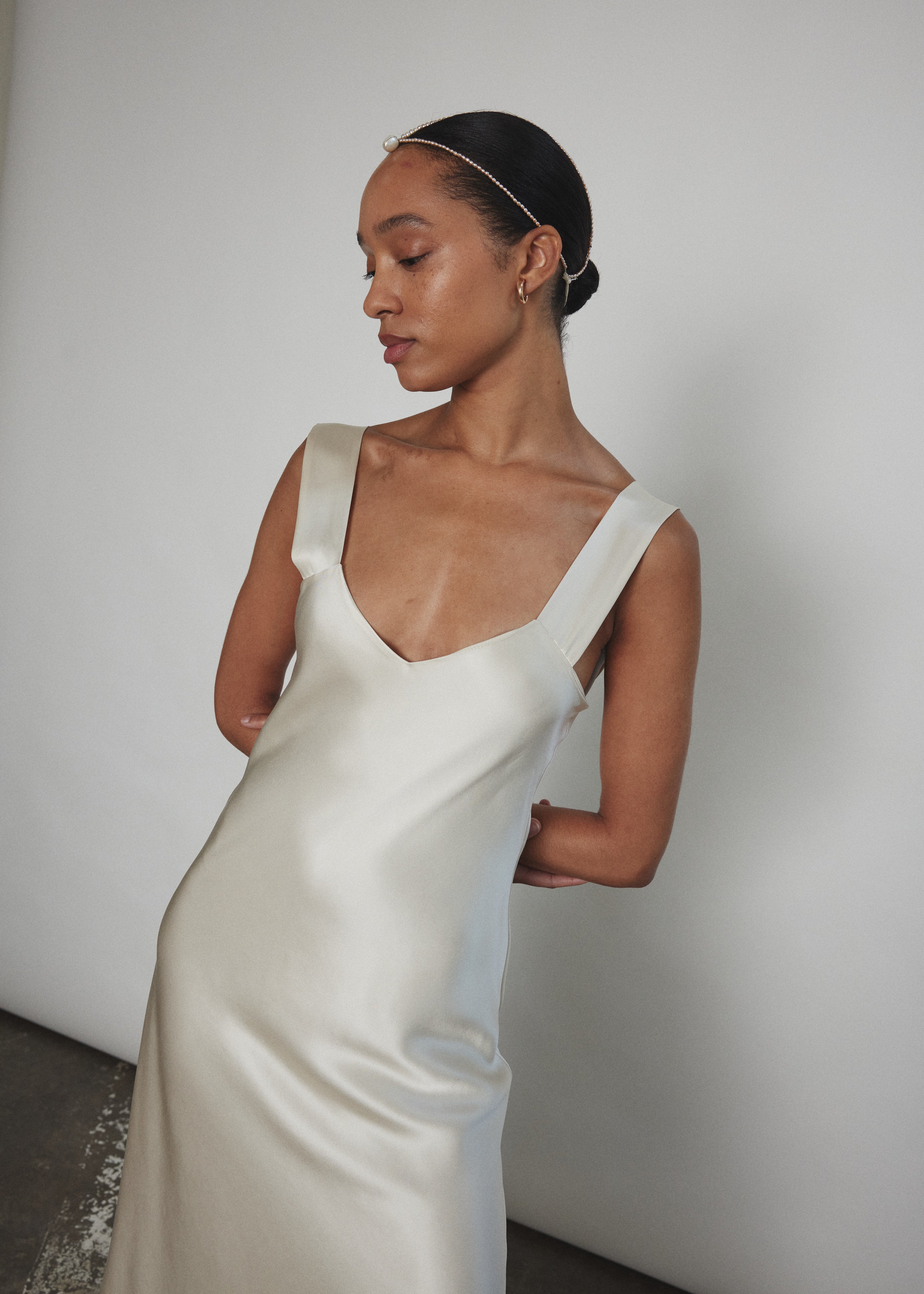 Editorial image of the ivory silk charmeuse Kamperett Lisette Midi Slip Dress.