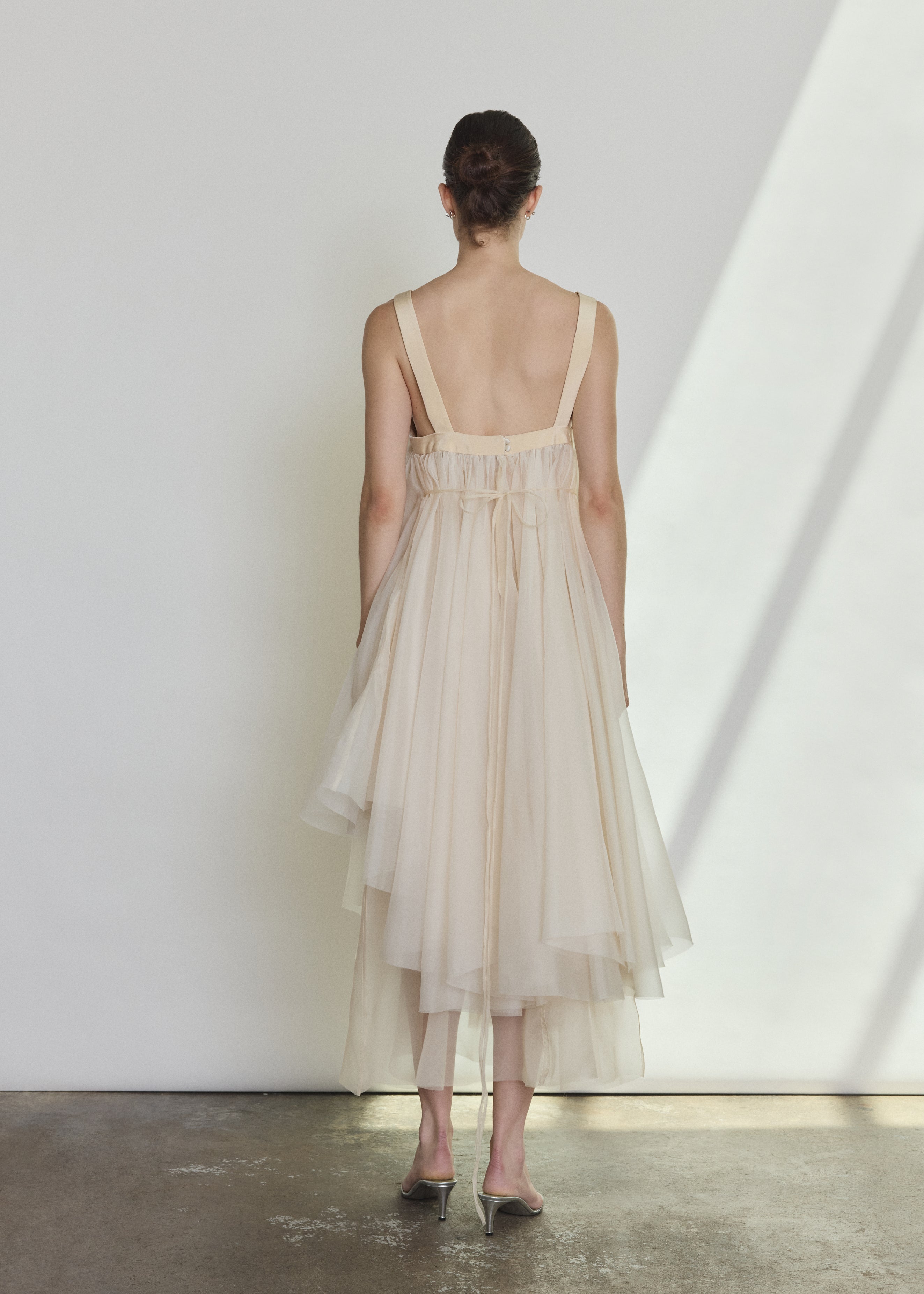 Back view of the ivory silk organza Kamperett Loie Dress with silk crepe straps and cord waist tie.