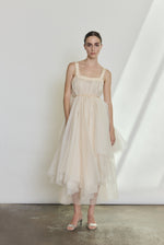 Detail of the ivory silk organza Kamperett Loie Dress showing the asymmetrical tier construction and silk cord waist.