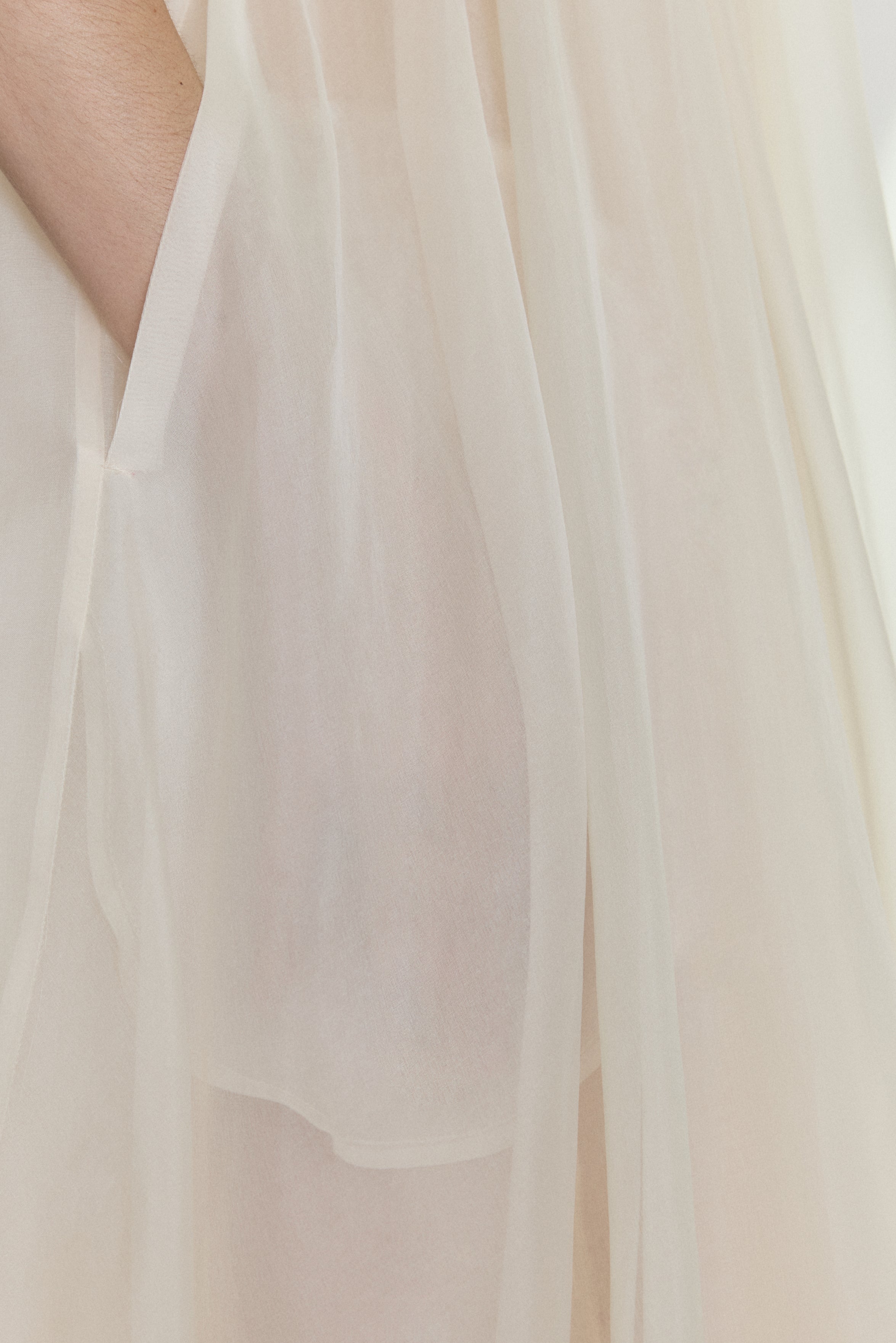 Editorial image of the ivory Kamperett Loie Dress showing the sheer organza tiers with motion.