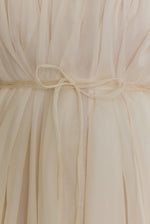 Editorial image of the ivory Kamperett Loie Dress, a modern bridal silk organza midi with hand-applied detail.