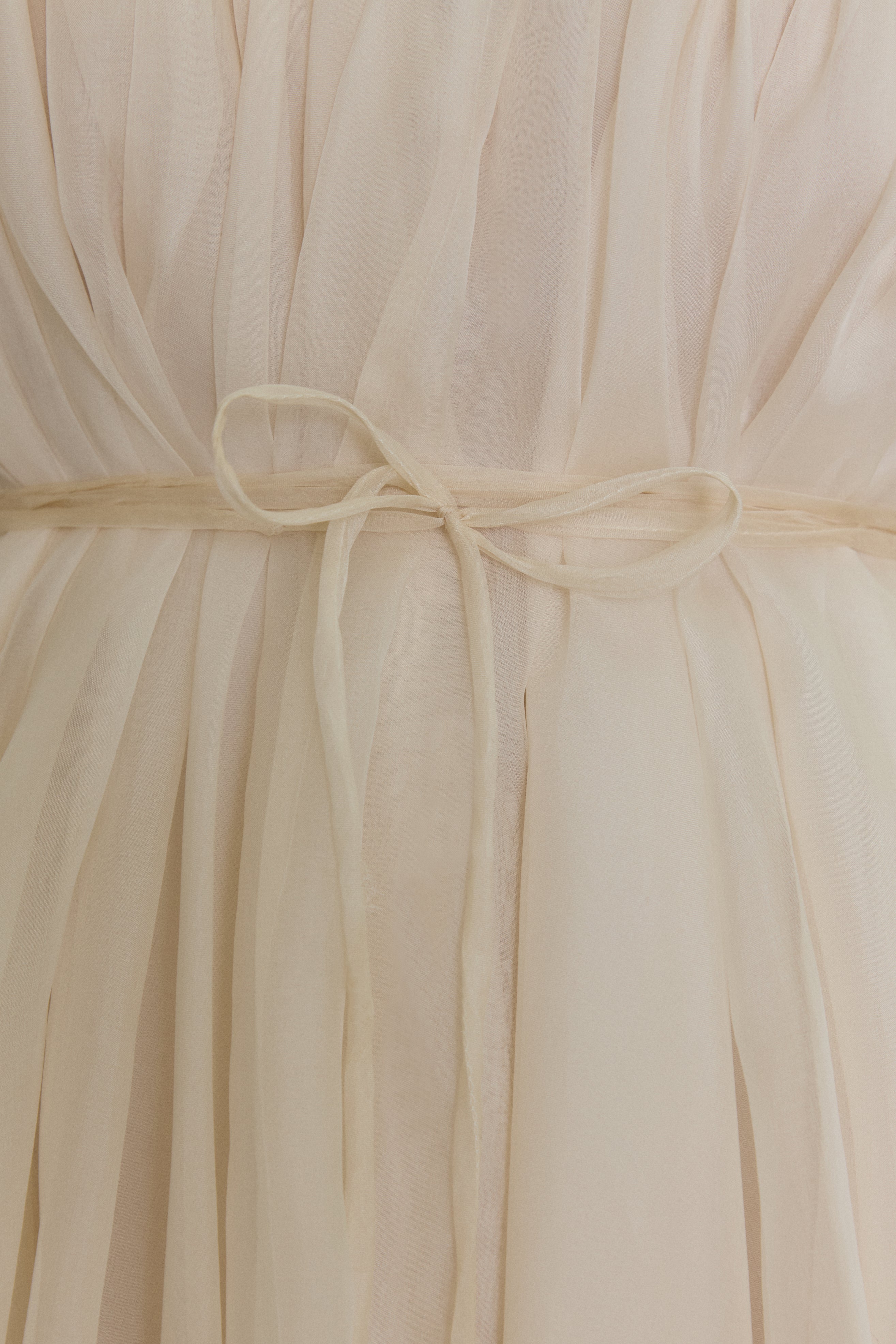 Editorial image of the ivory Kamperett Loie Dress, a modern bridal silk organza midi with hand-applied detail.